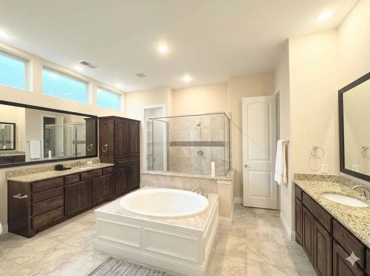 Large bathroom featuring a built-in soaking tub, a separate glass-enclosed shower, dual vanities with granite countertops, and extensive dark wood-finish cabinetry