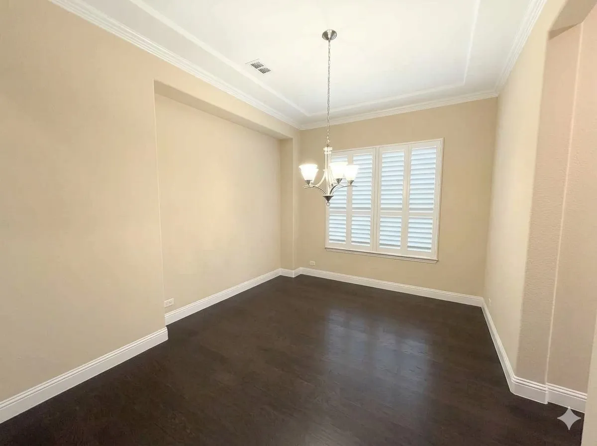 Dark wood-finish flooring with white baseboards