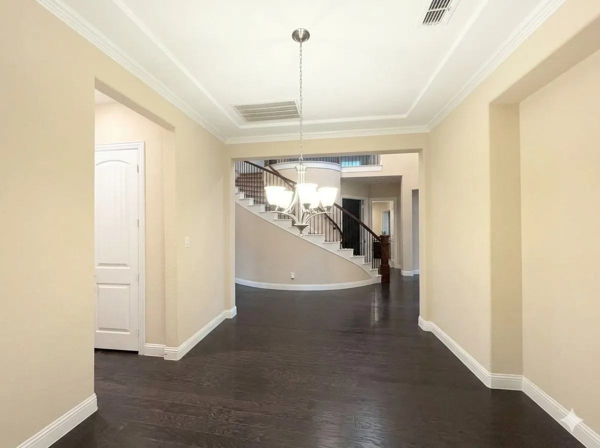 Dark wood-finish flooring with white trim