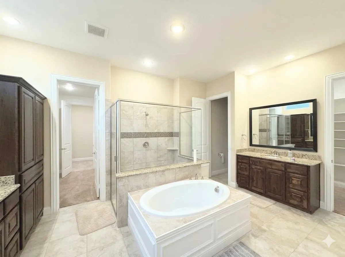 Soaking tub with tiled surround, separate glass-enclosed shower, dual vanity with undermount sink, dark wood-finish cabinetry, and recessed lighting