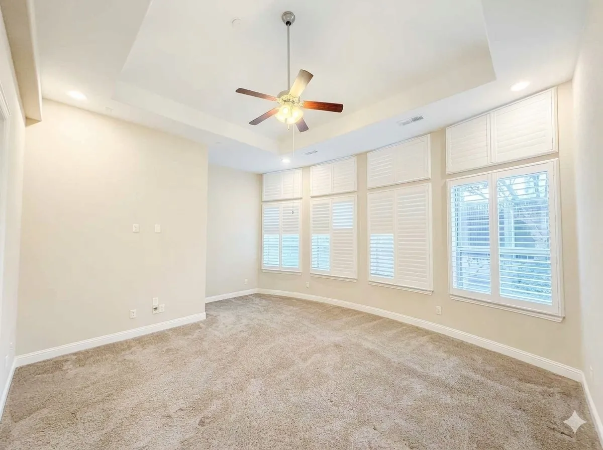 Recessed lighting, ceiling fan, tray ceiling, carpeted flooring, and window shutters