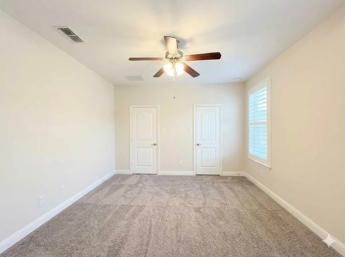 Recessed lighting, ceiling fan with light fixture, window with plantation shutters, and light-colored carpet flooring