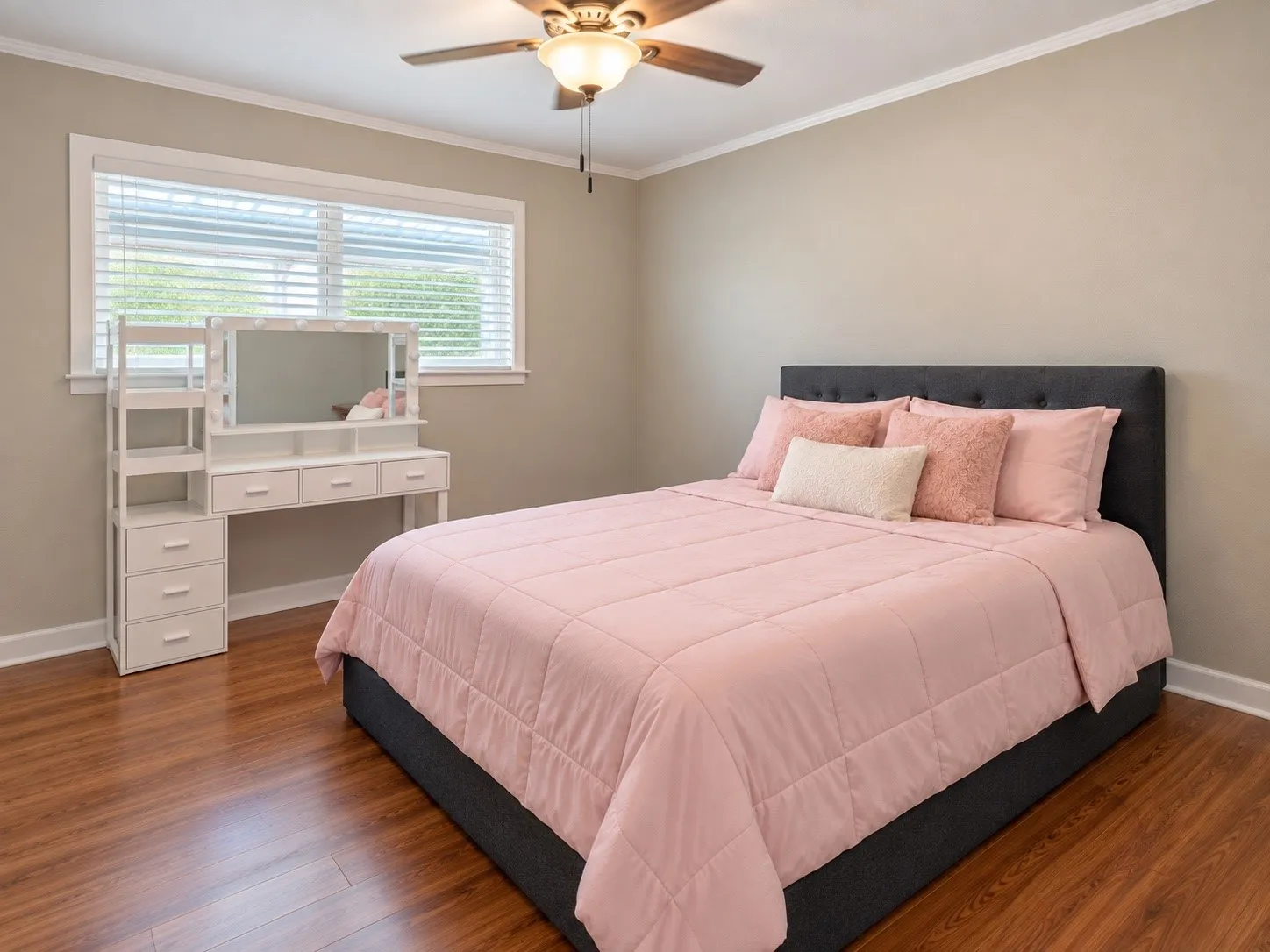 Warm wood-finish flooring, neutral wall paint, and a multi-pane window with horizontal blinds