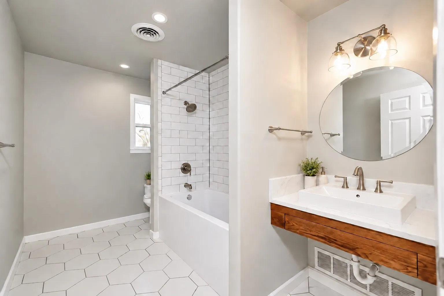 Bathroom featuring hexagon floor tile, a subway tile shower surround, and a floating wood-finish vanity with a vessel sink