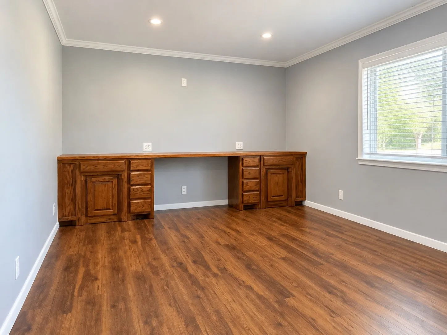 Den/2nd Living or 4th Bedroom Built-in wood-finish desk with integrated cabinetry, wood-finish flooring, recessed lighting, and a window with blinds