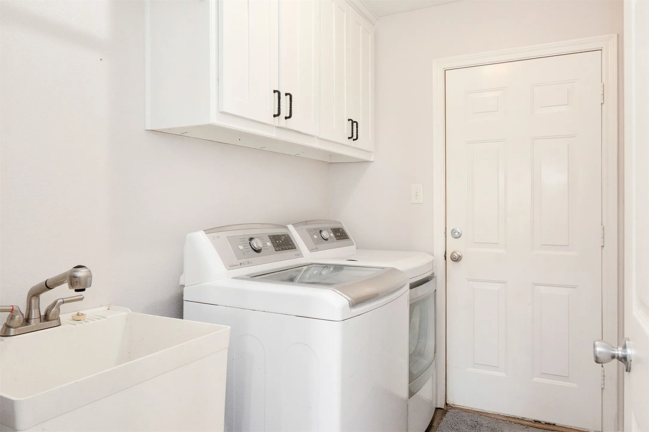 Laundry room with separate wash sink right off the garage.