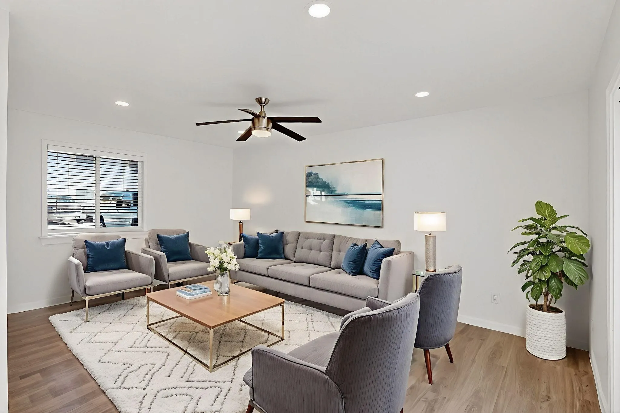 Recessed ceiling lighting, wood-finish flooring, white window blinds, and a ceiling fan with integrated lighting