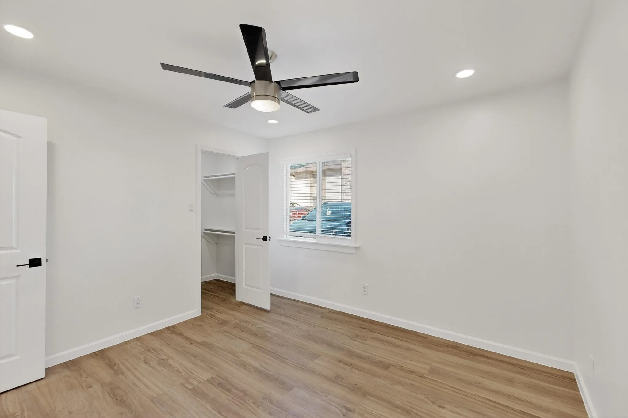 Wood-finish flooring, recessed lighting, and a contemporary ceiling fan with light