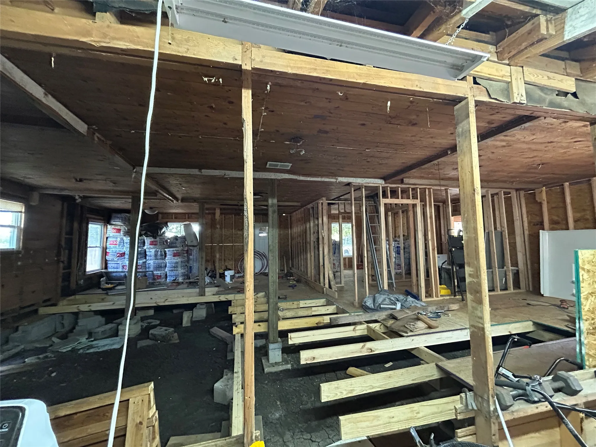 inside of home with all new floor support and partially complete subflooring