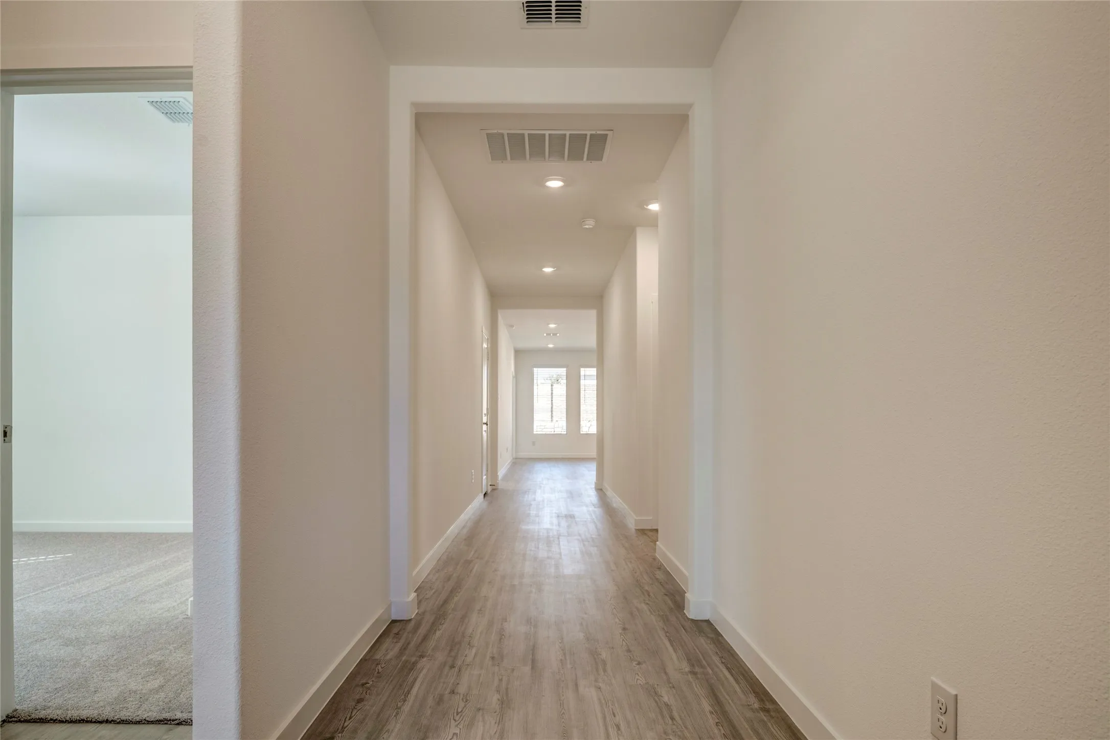You can see straight to the back yard from the front door. Wider than usual hallway.....lots of lighting....