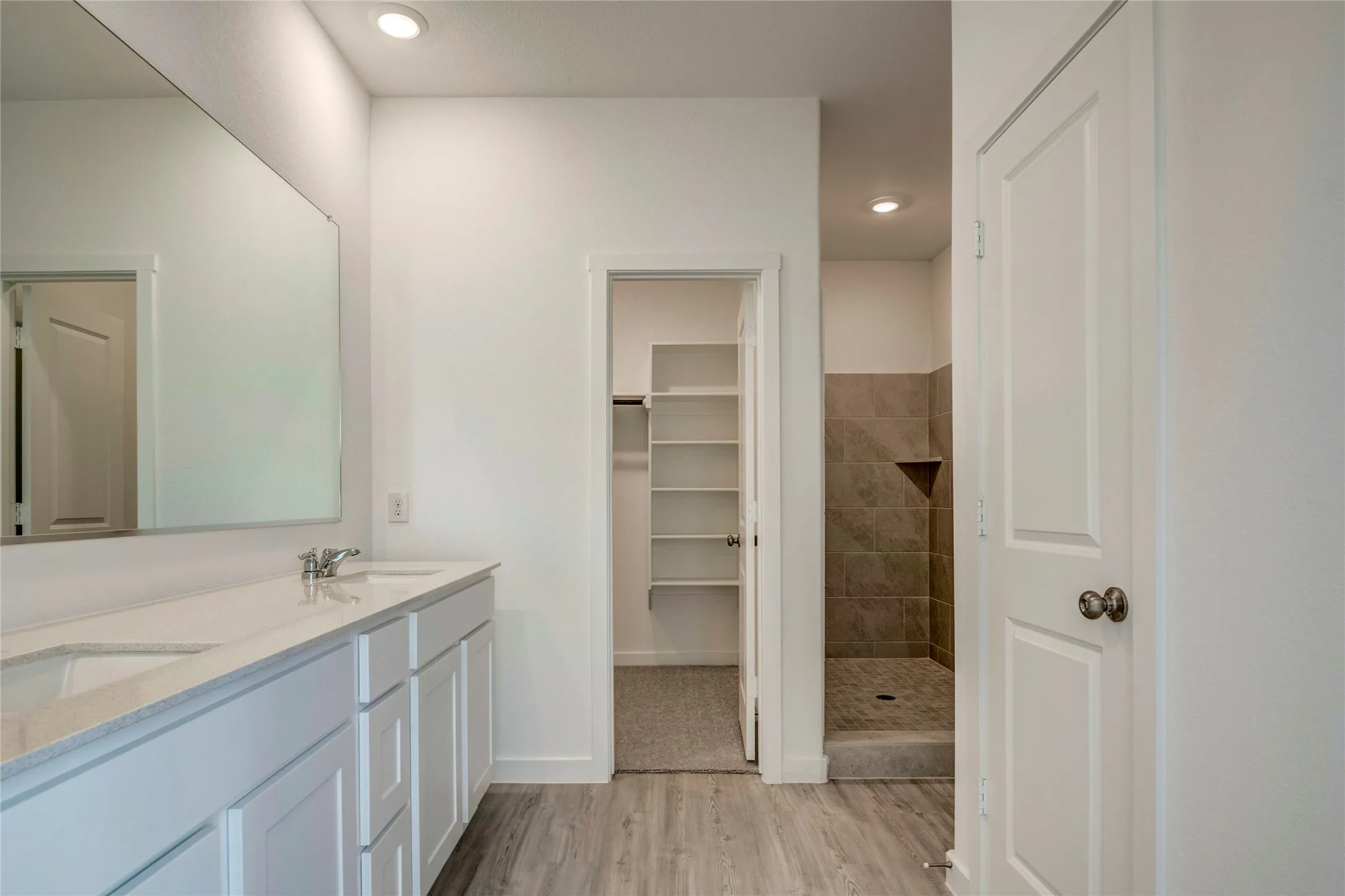 Amazing primary bath featuring dual sink vanity with undermount sinks and lovely light-toned countertops, with access to the large closet and toilet in it's own enclosed area.....