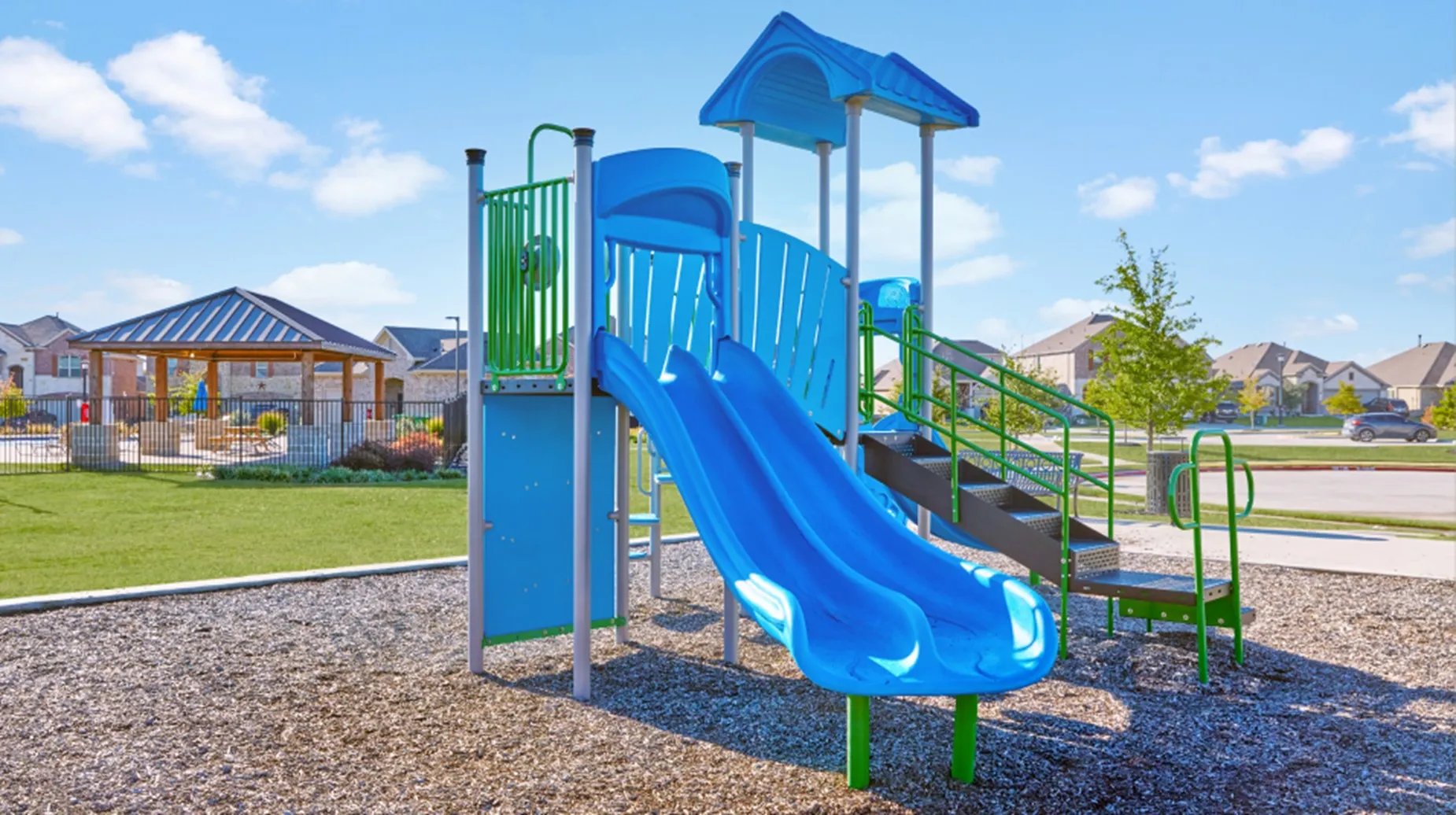 Nearby playground with slides, stairs, and climbing features