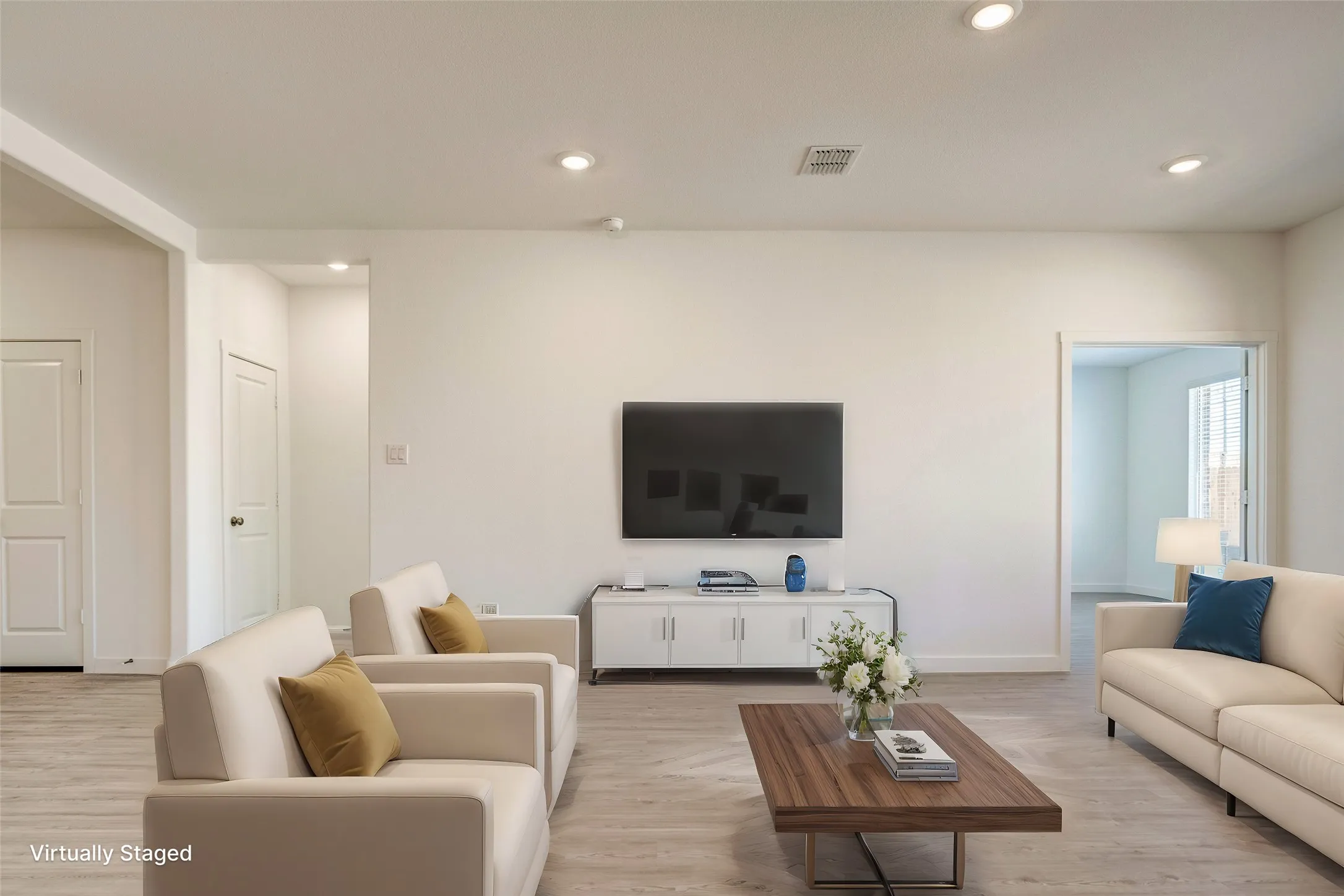 Another virtually staged option for how the living space can be set up. That room to the right could be set up as an office or media room, a great flex space looking onto the back yard....