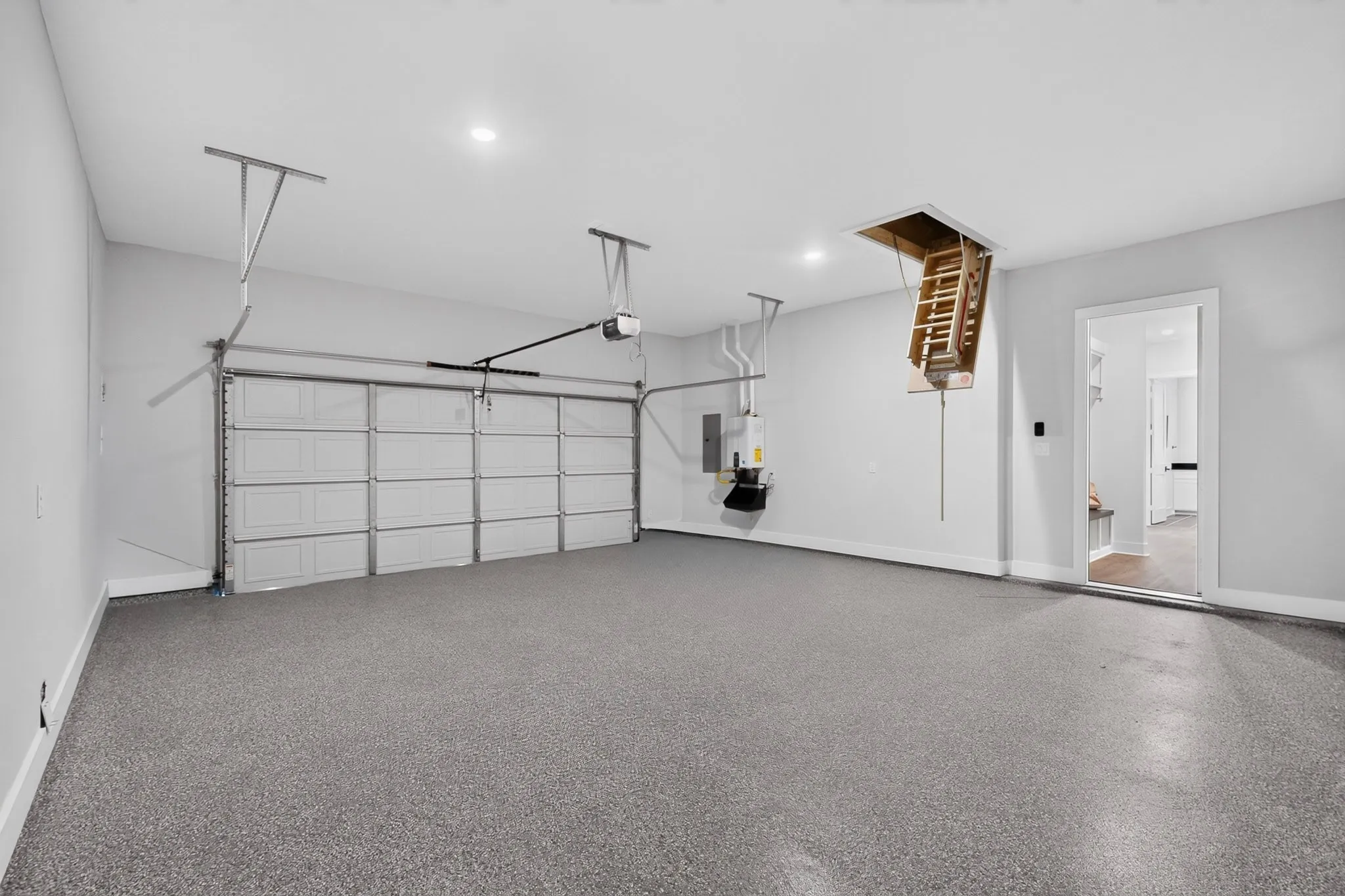 Garage, epoxy floor, recessed lighting and attic access with a pull-down ladder