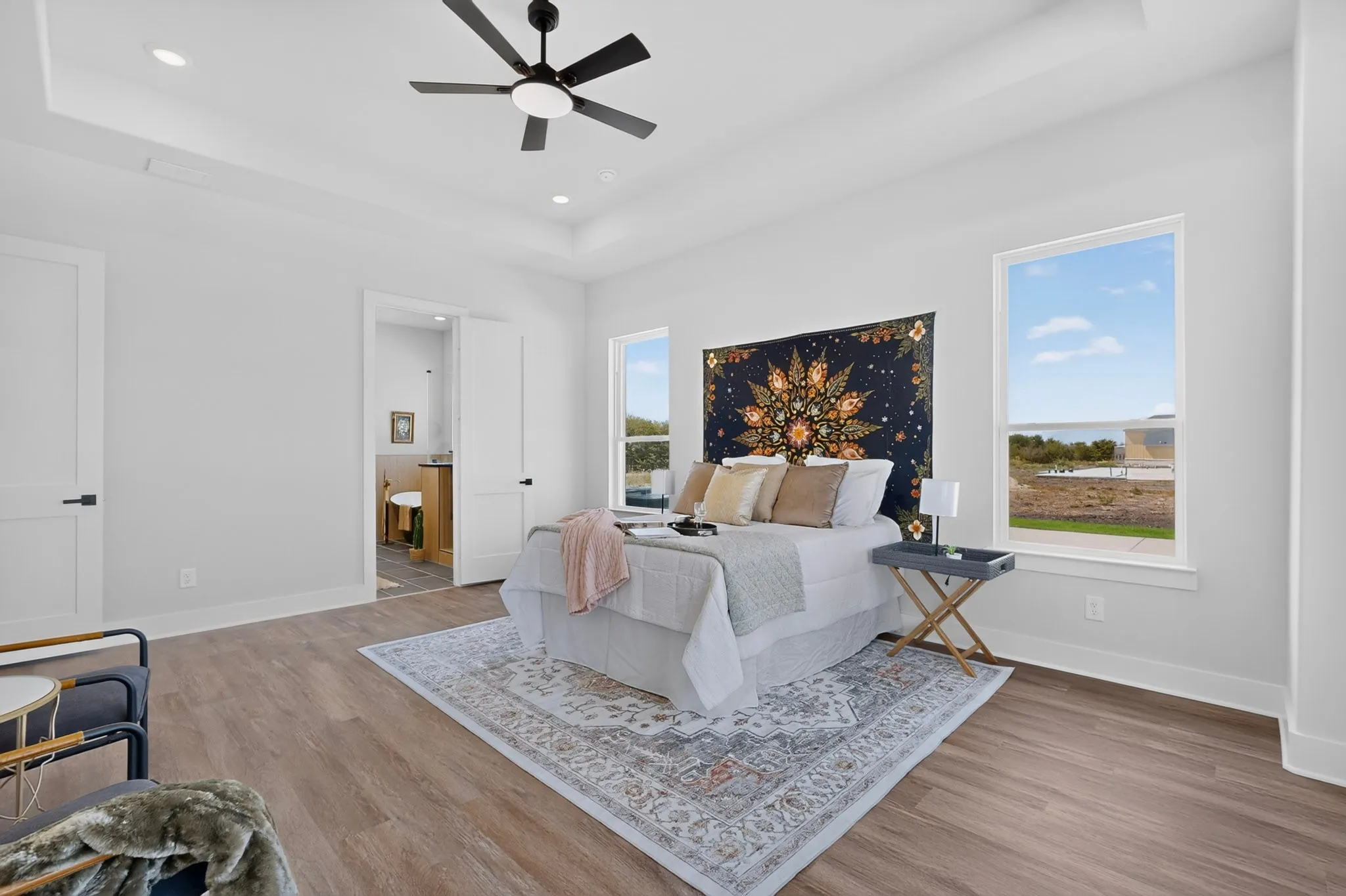 Tray ceiling with a ceiling fan, recessed lighting, laminate flooring