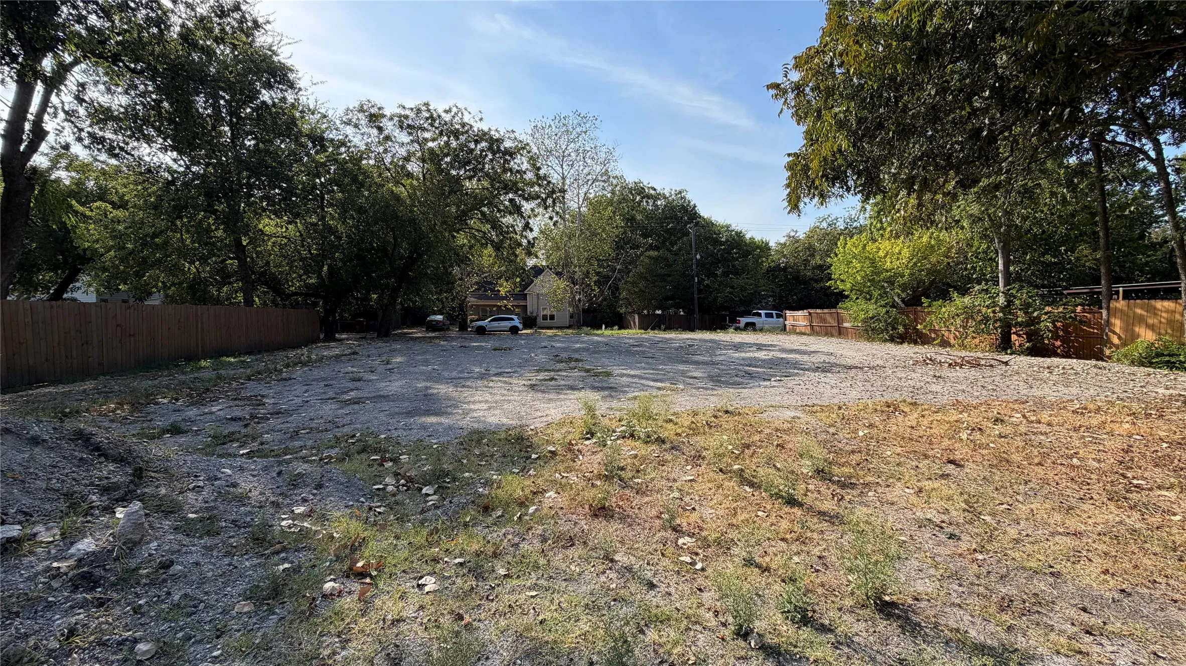 Expansive lot featuring mature trees and a perimeter fence