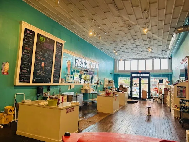 Hardwood flooring, high ceilings with recessed lighting, full-length windows, and a glass-paneled entry door