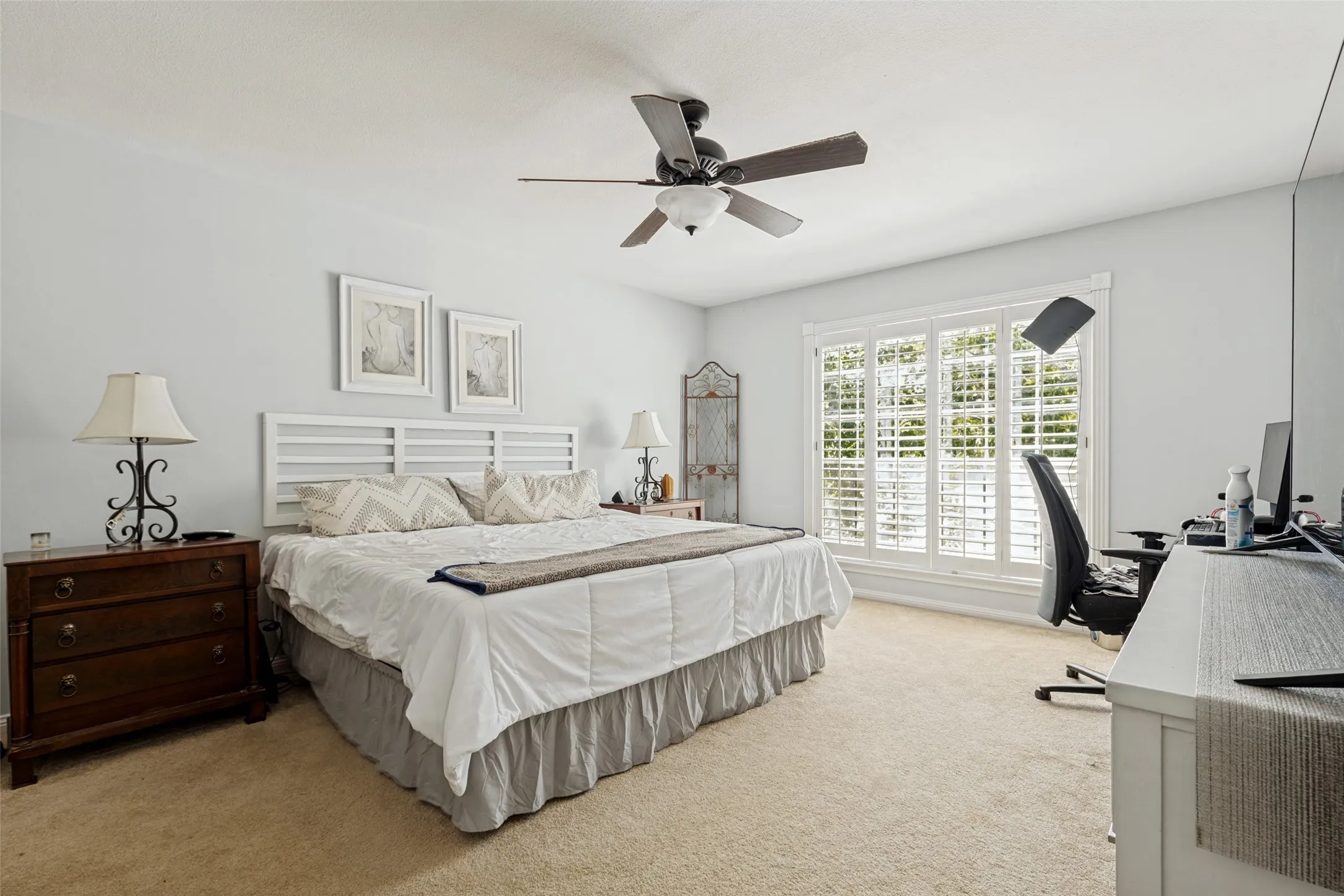 Recessed lighting with a ceiling fan, light-toned walls, and a large window with plantation shutters