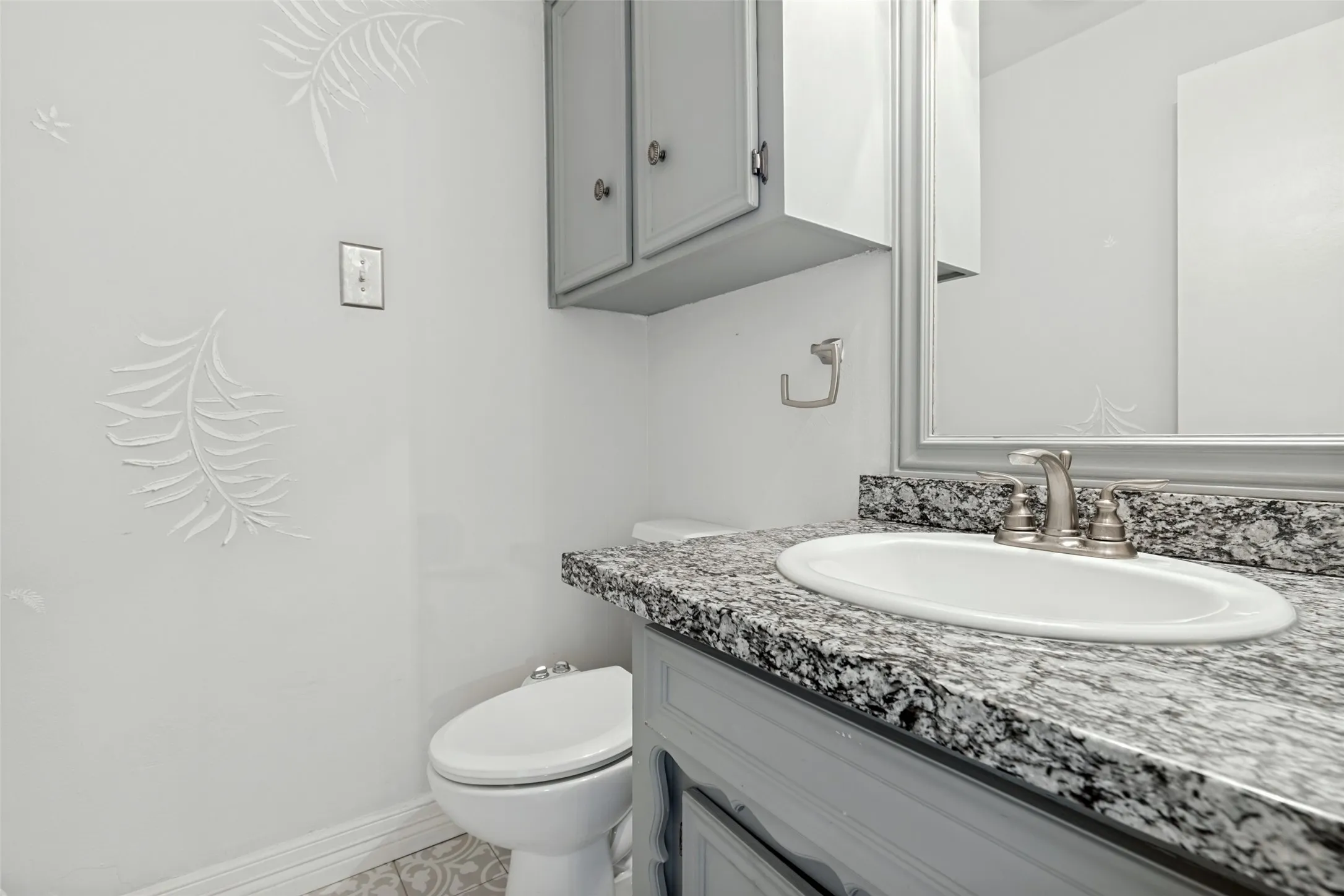 Vanity with patterned countertop and integrated sink
