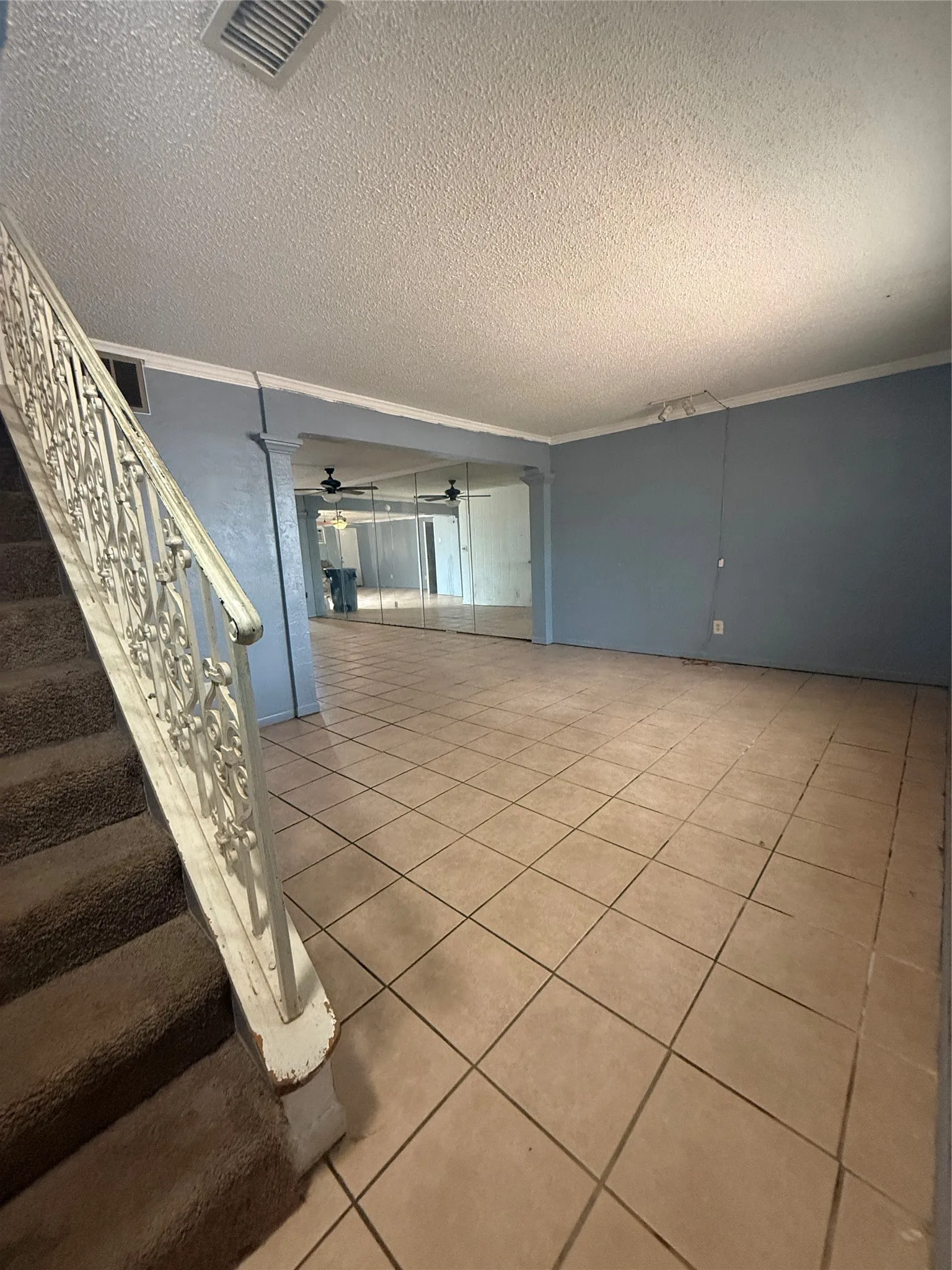 Views as you enter in your front door! Large living area flowing into a dining area with a Wall of Mirrors