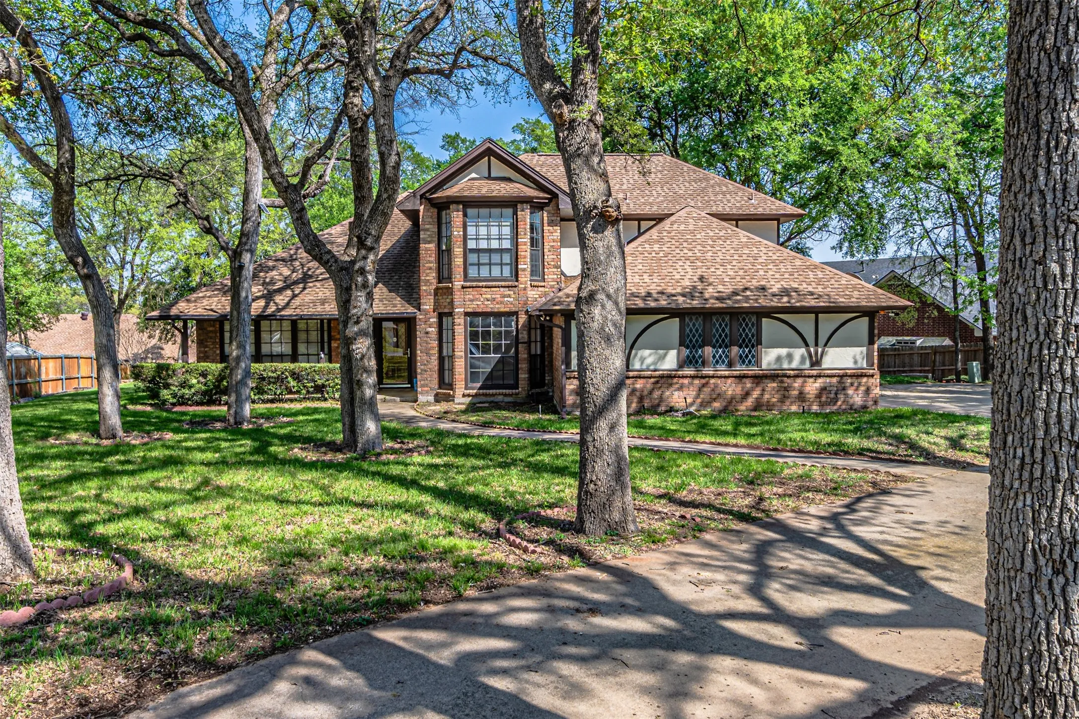 Brick and siding exterior with multiple gables and a prominent bay window