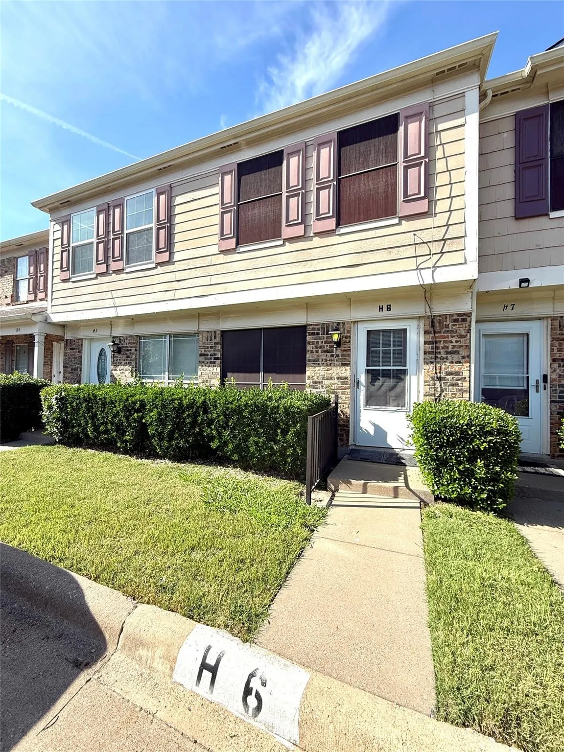 Two-story townhome featuring brick and siding exterior