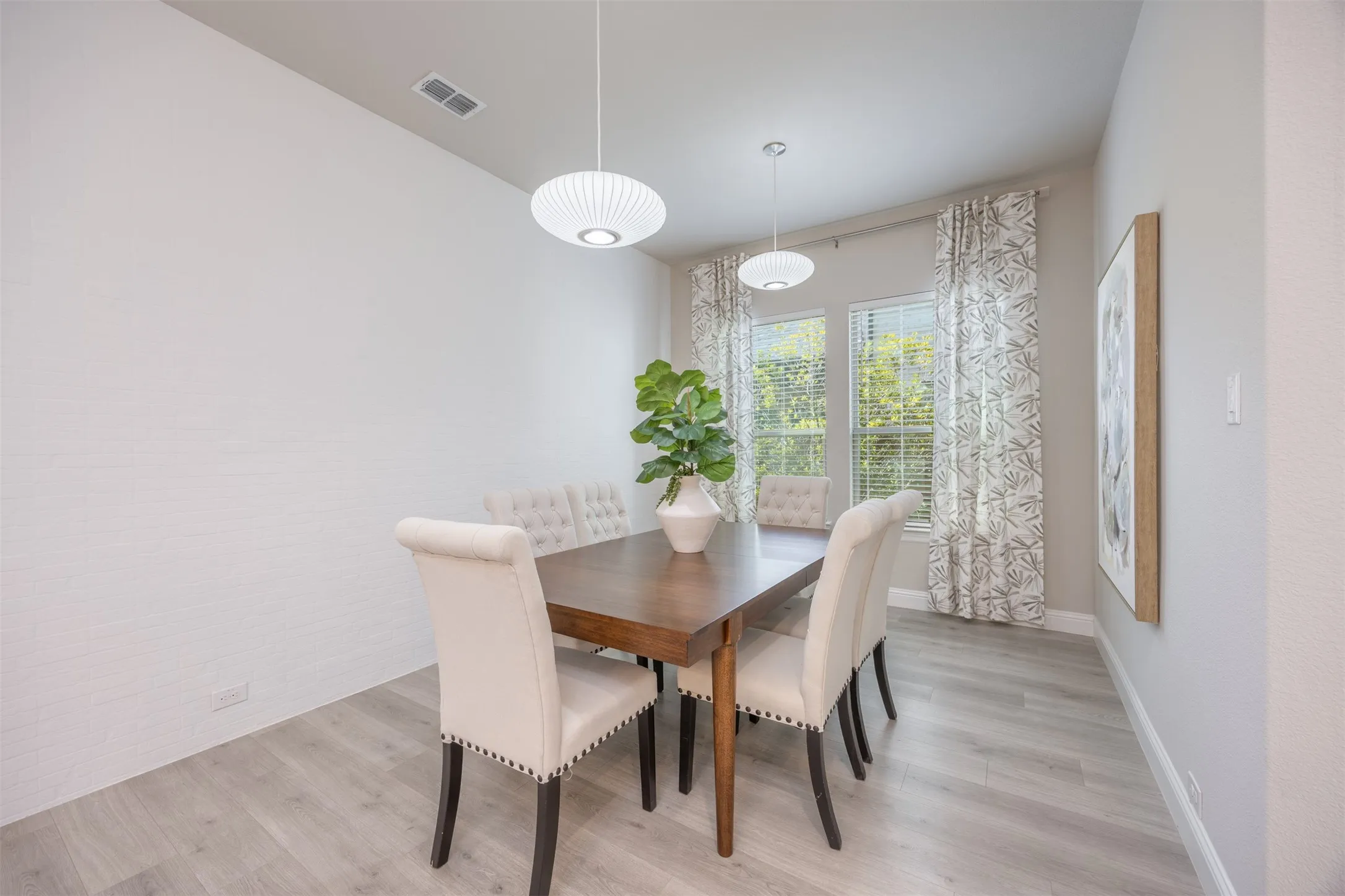 Separate dining area with a painted brick accent wall