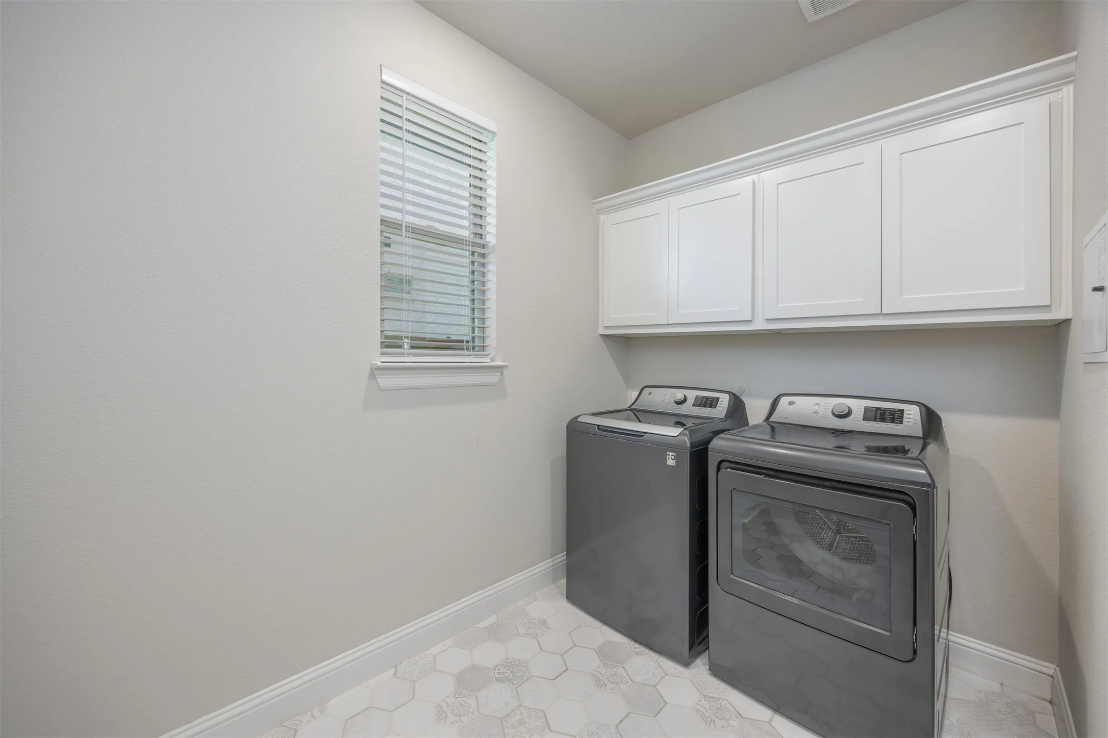 Expansive laundry room with space for an extra fridge, folding table or ironing board