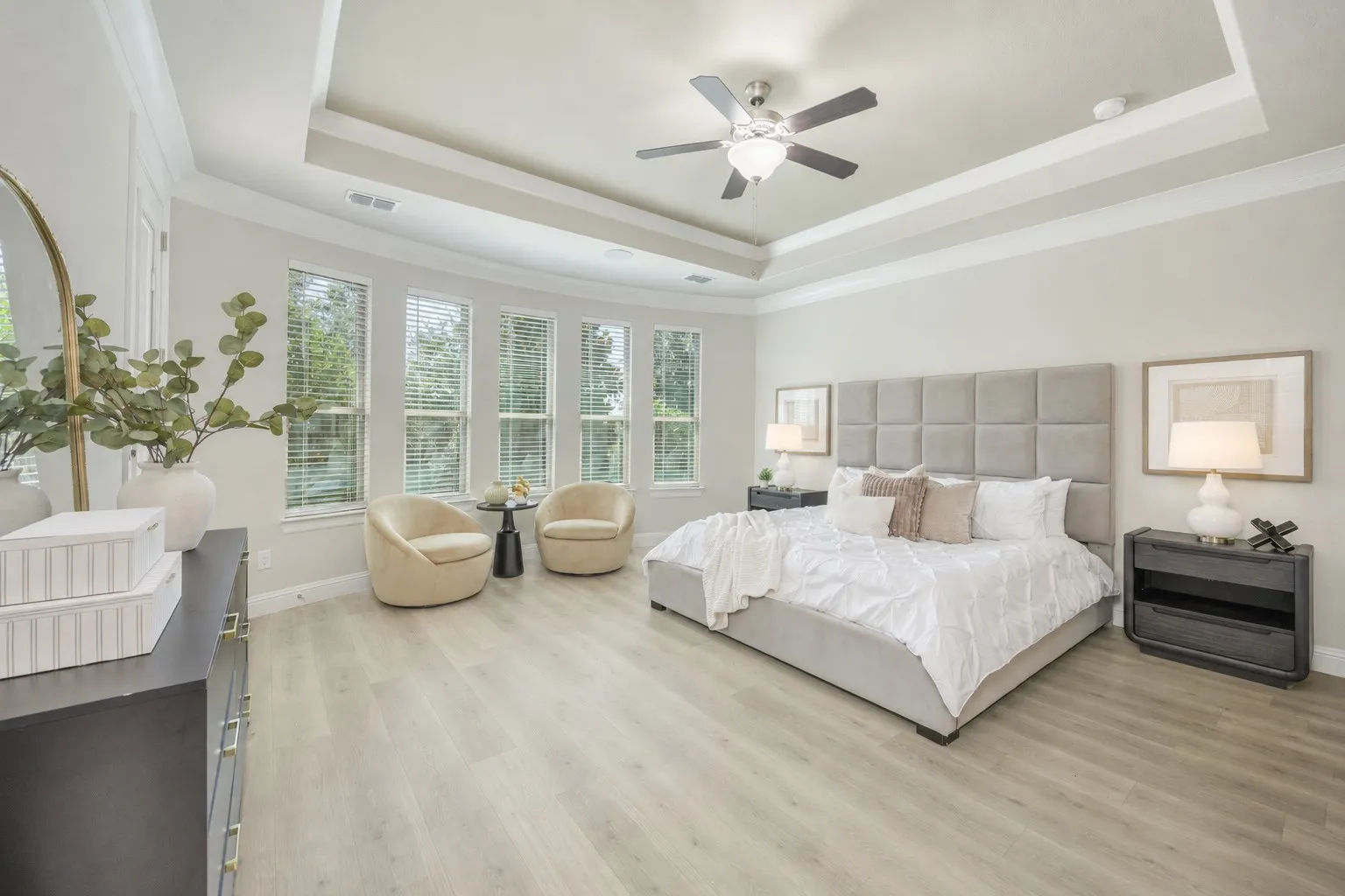 Spacious primary bedroom with a bay window.