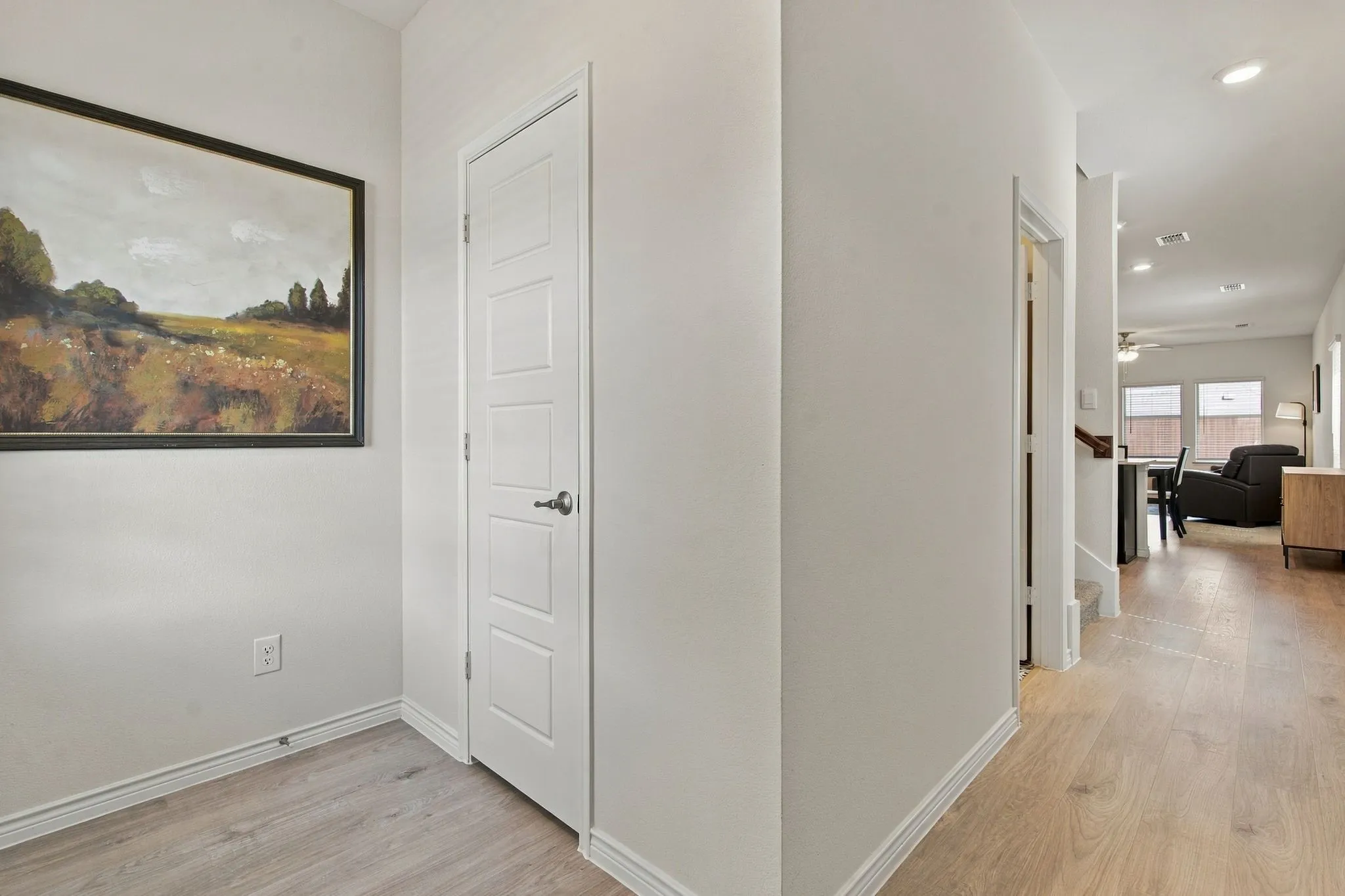 Light wood-finish flooring and white baseboards throughout