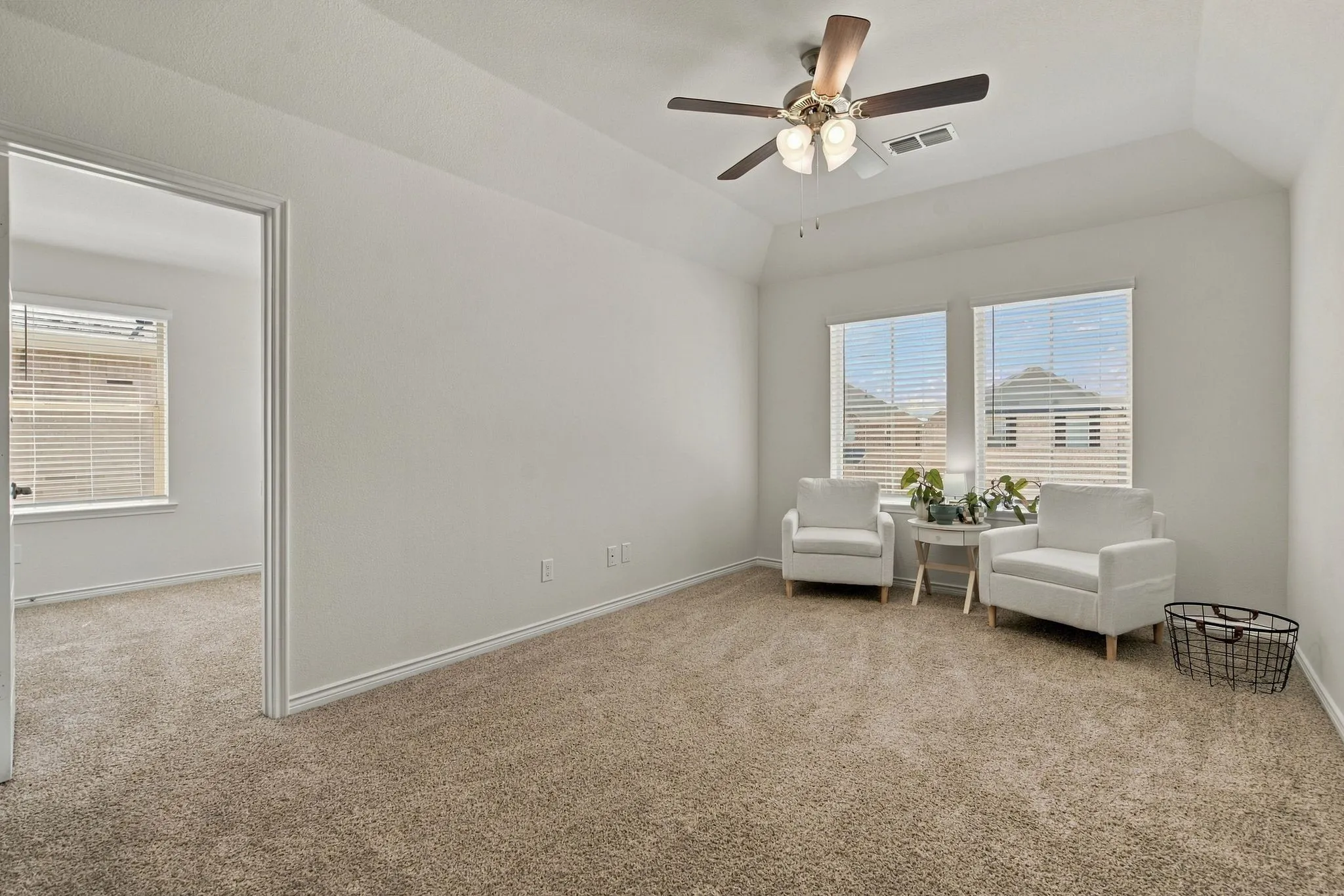 Large entertainment space, vaulted ceiling, and ceiling fan with integrated lighting