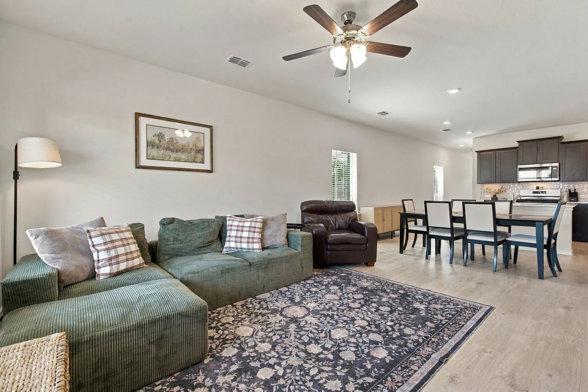 Bright with wood-finish flooring throughout and ceiling fam