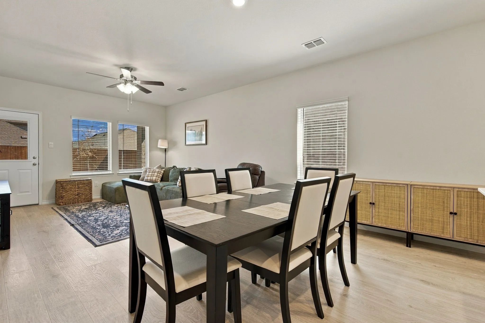 Open-concept living space featuring light wood-finish flooring, recessed lighting, and a ceiling fan