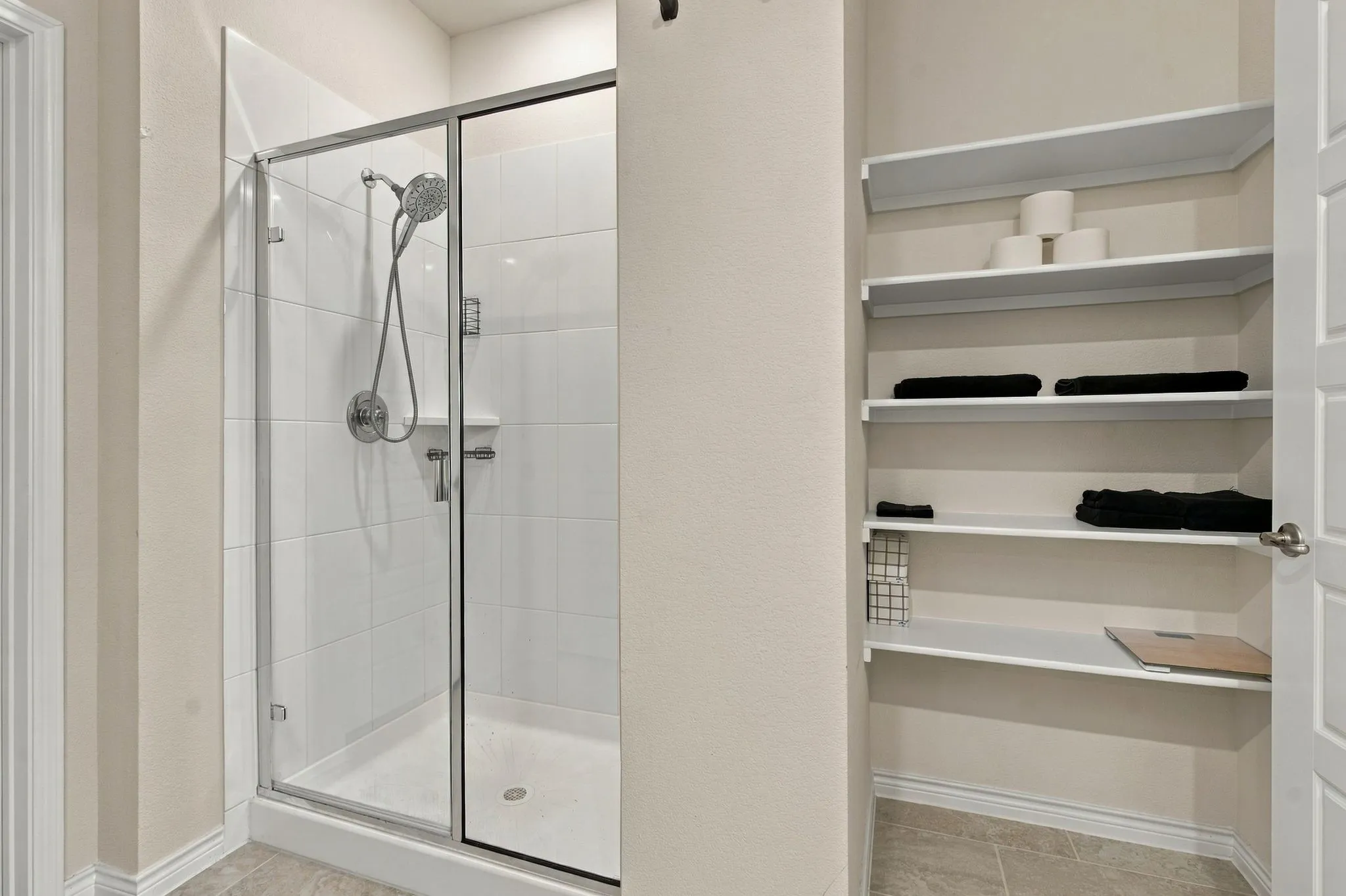 Primary bathroom Walk-in shower with clear glass enclosure and chrome fixtures