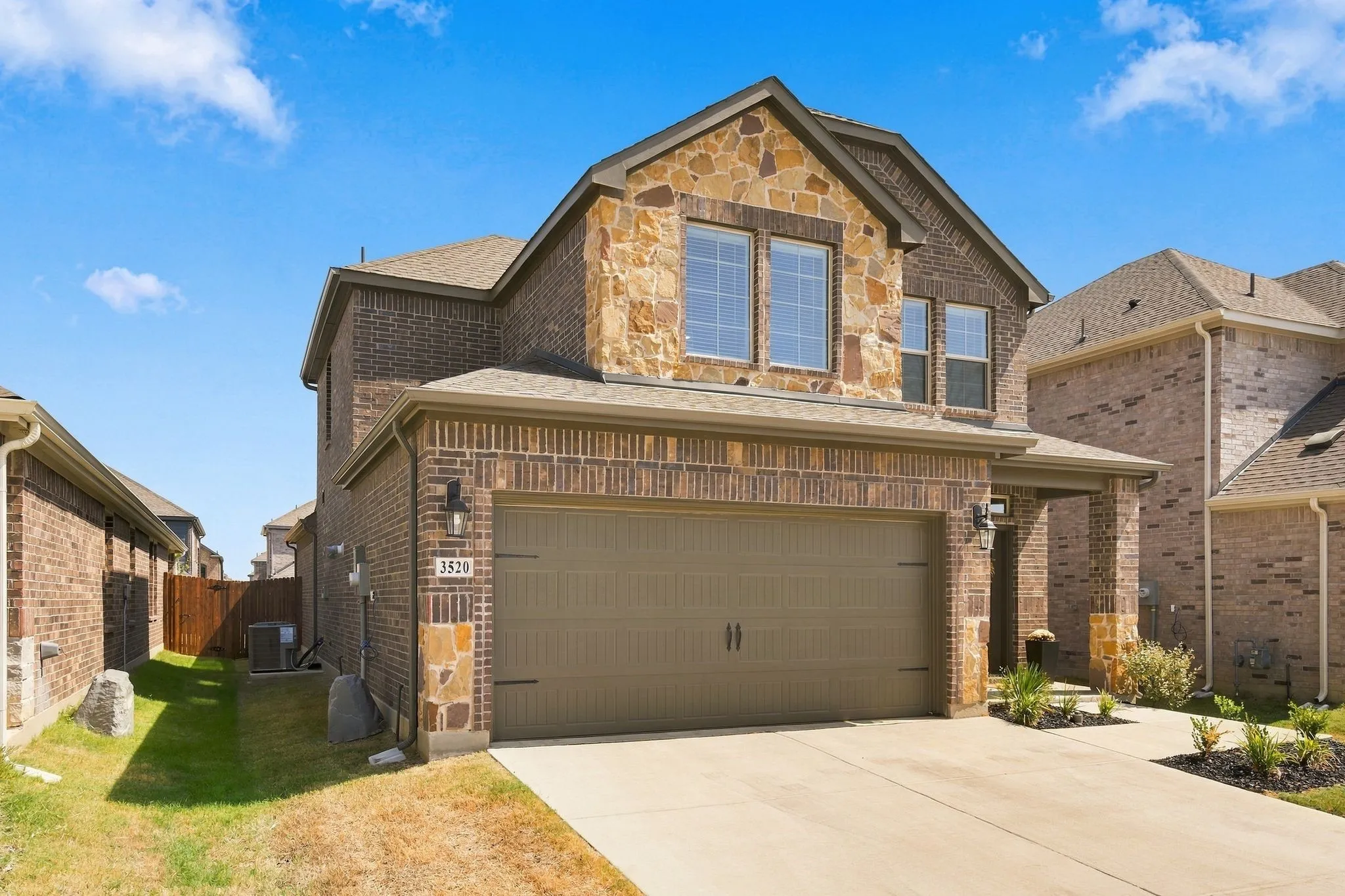 Lovely Brick and stone veneer exterior with gabled roofline