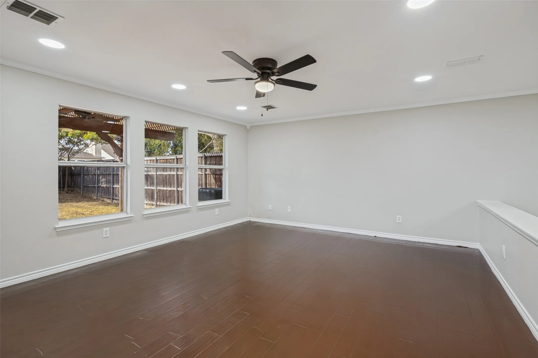 Wood-finish flooring, recessed lighting, and a ceiling fan with light