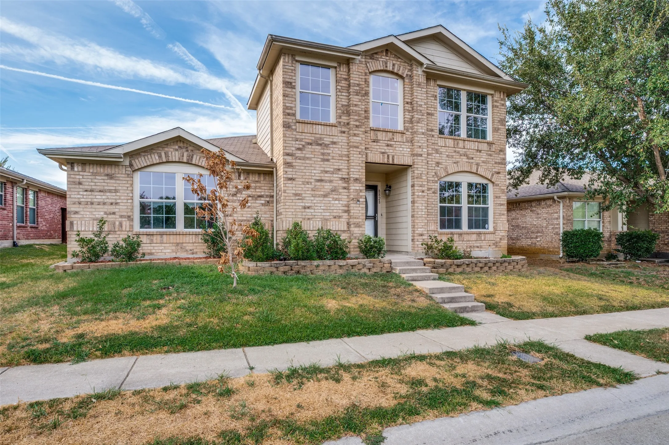 Two-story brick exterior with arched window details