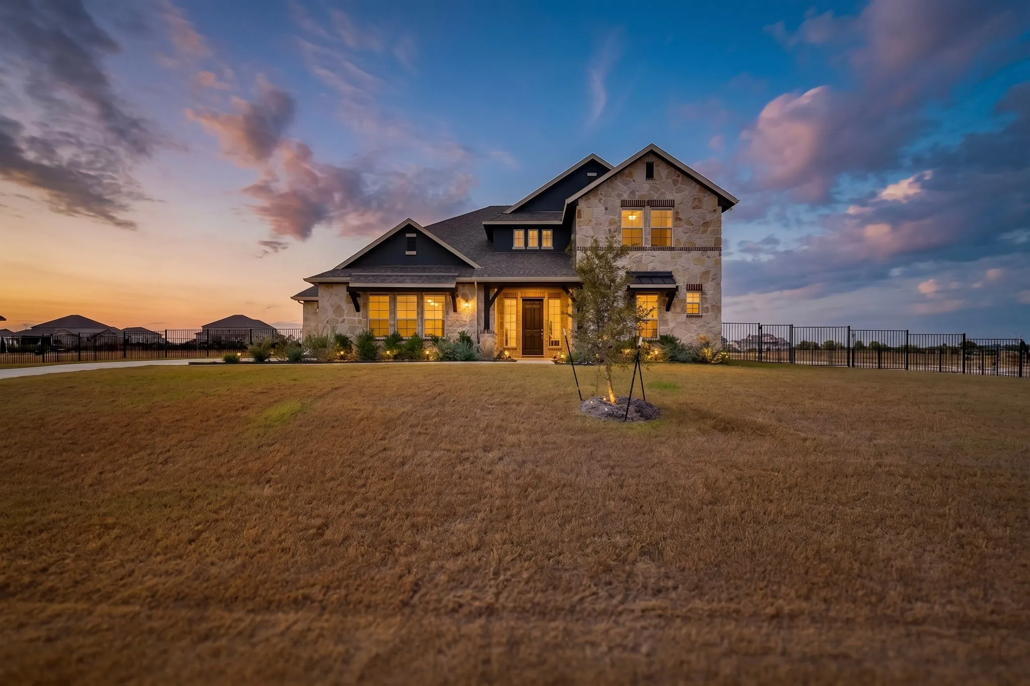 Stone facade with dark trim accents, multiple gables, and a prominent front entry
