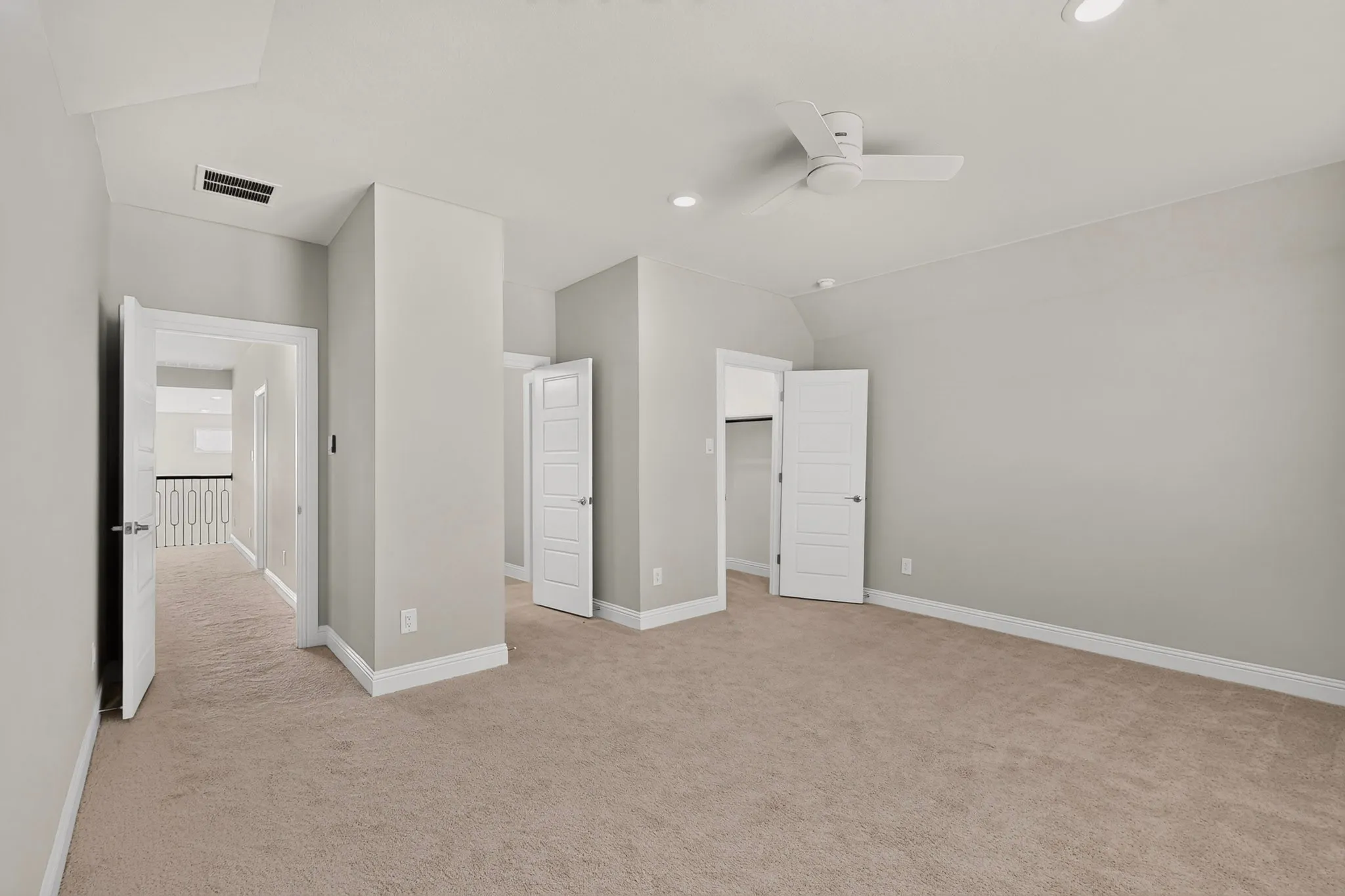 Carpeted room featuring recessed lighting, a ceiling fan, and multiple white paneled doors