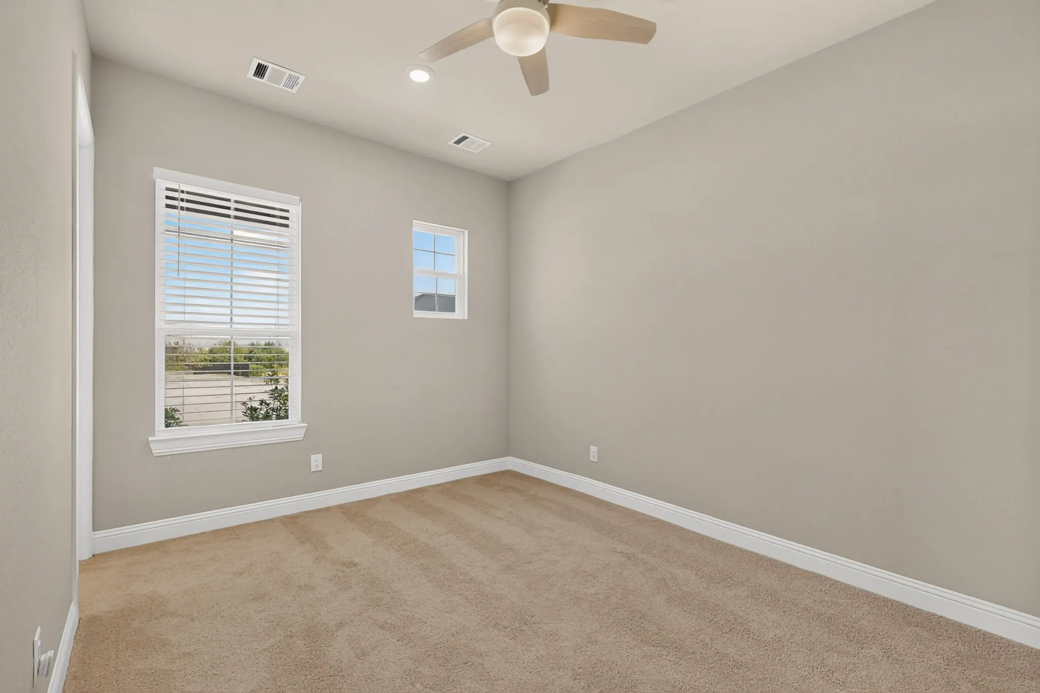 Neutral tone walls with light tan carpeting