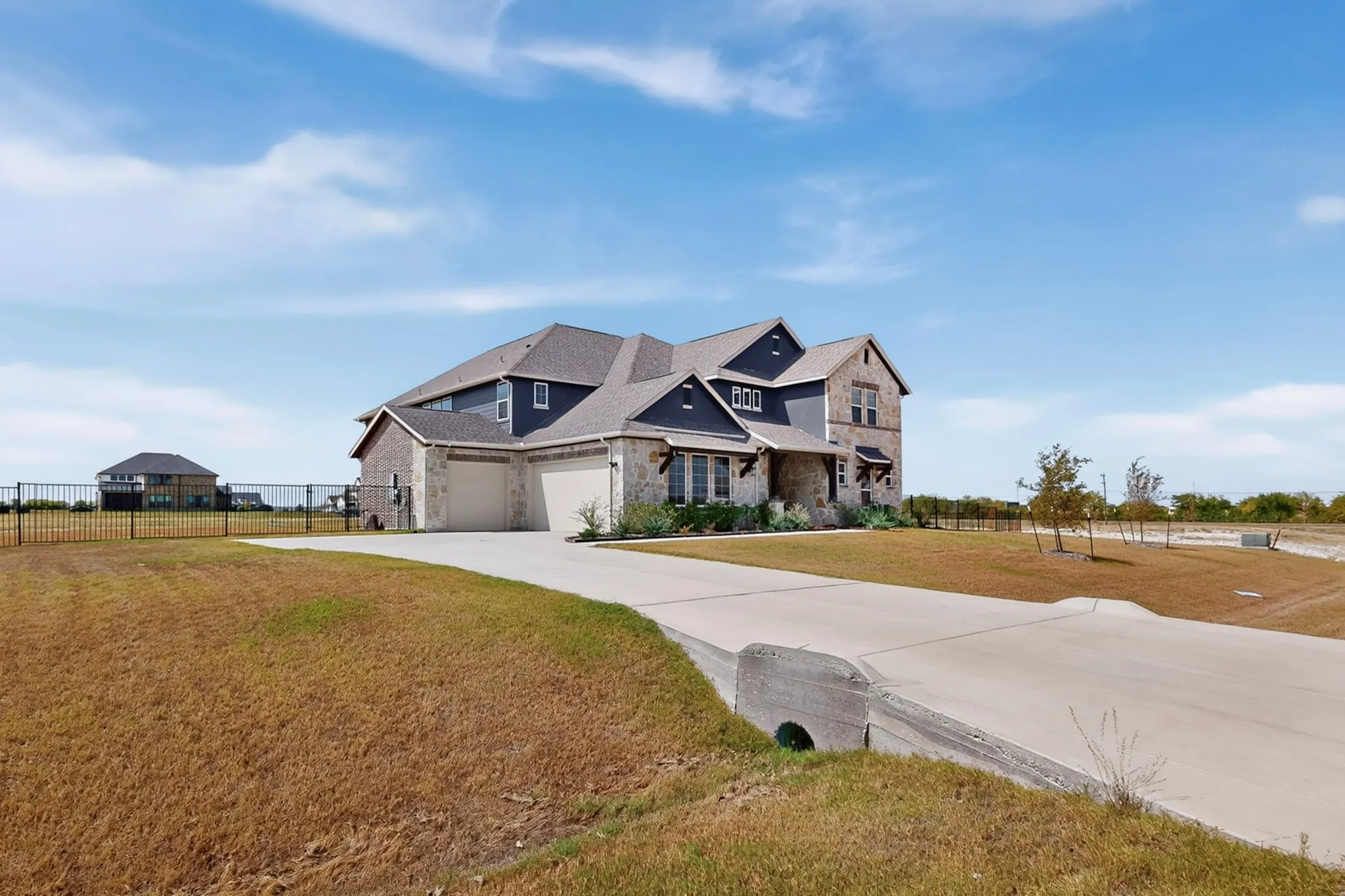 Stone and siding exterior with a two-car garage