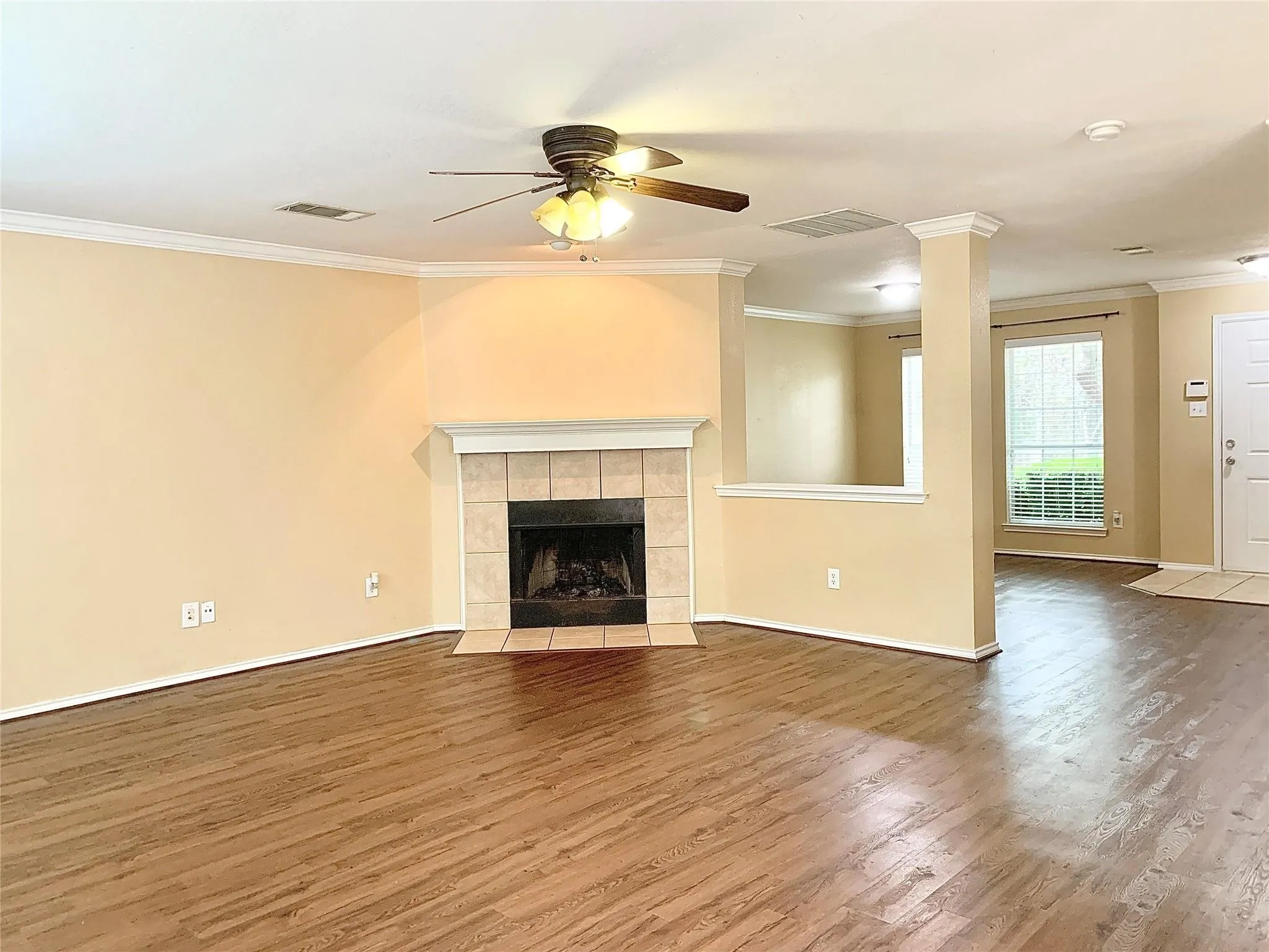 Warm wood-finish flooring complements the light-toned walls