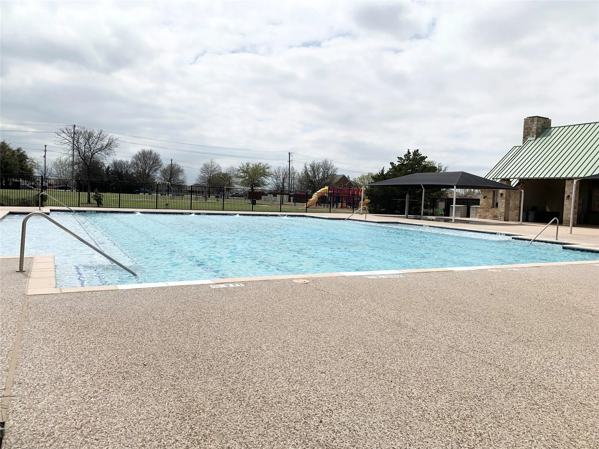 Expansive outdoor pool with integrated steps and handrails