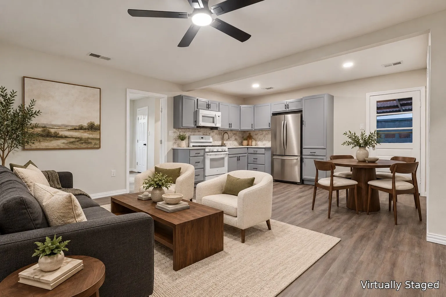 Open-concept living area featuring wood-finish flooring, recessed lighting, and a ceiling fan