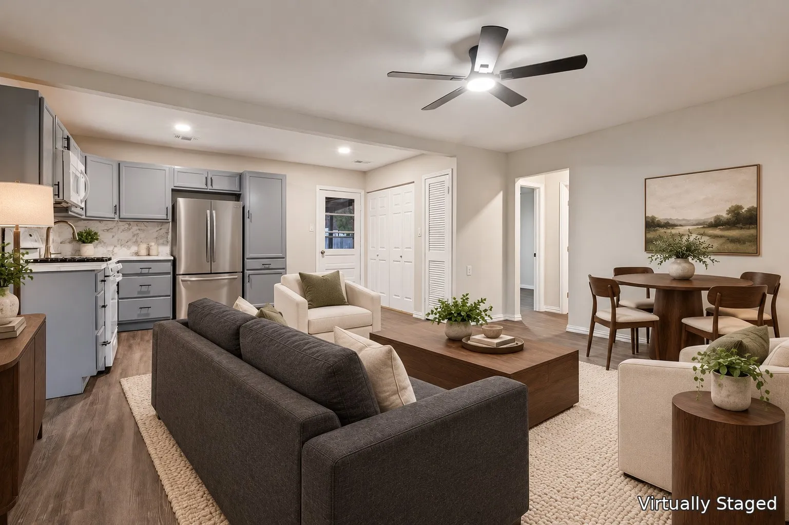 Open-concept living space featuring wood-finish flooring, a modern ceiling fan, and recessed lighting
