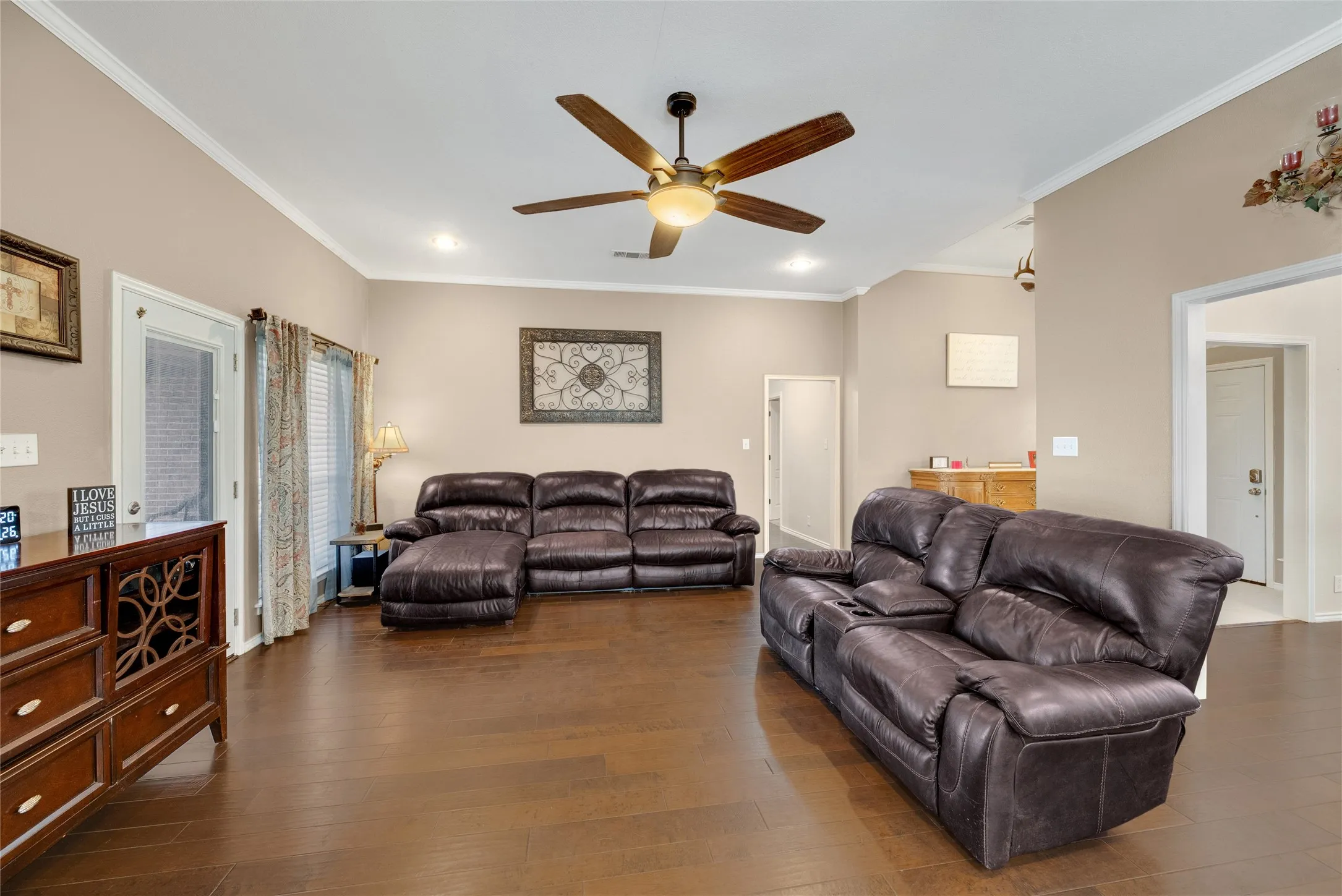 Wood-finish flooring, vaulted ceilings, crown molding, recessed lighting, and a ceiling fan