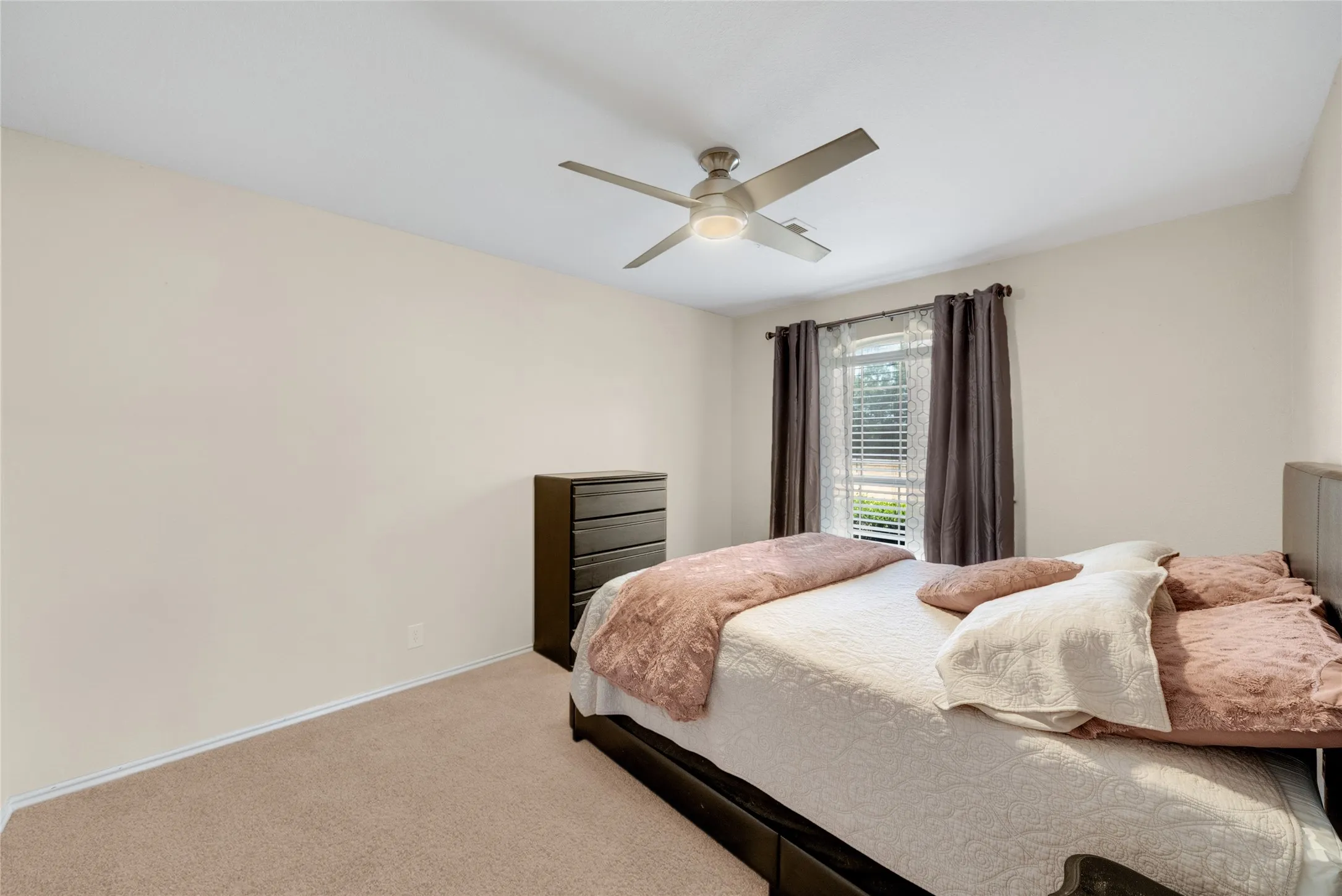 Carpeted flooring, window with blinds, ceiling fan with integrated lighting