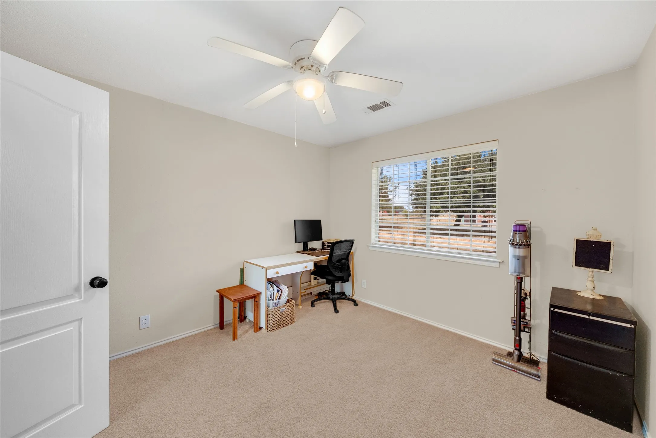 Neutral-toned walls complement the carpeted flooring