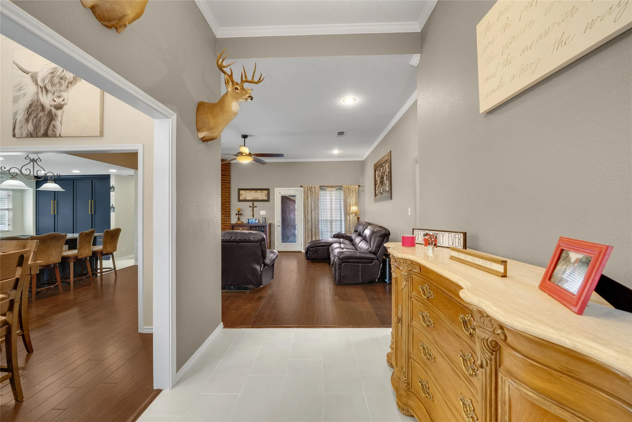 White tile flooring, wood-finish flooring, recessed lighting, and crown molding