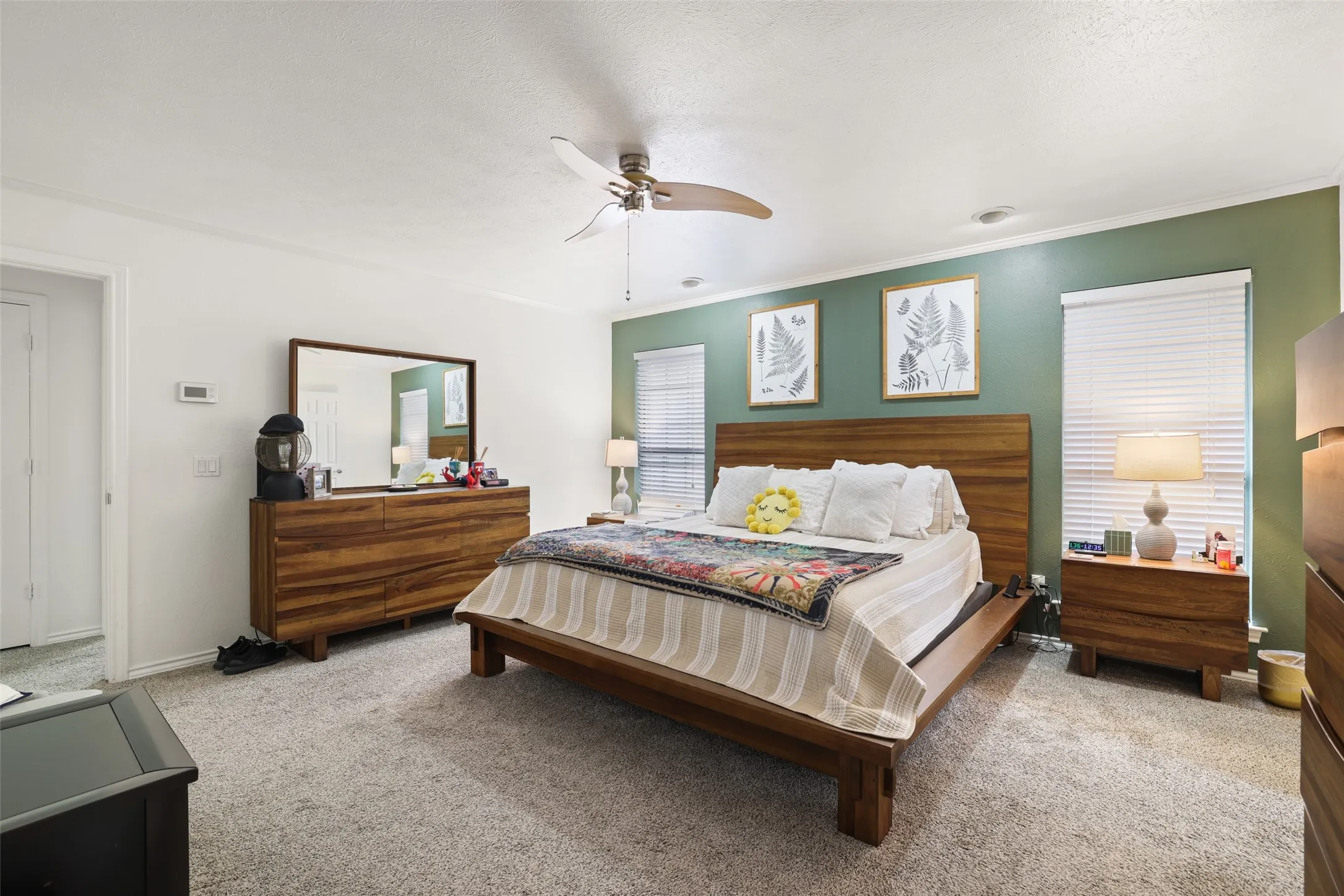 Wall-to-wall carpeting, overhead ceiling fan, and window blinds